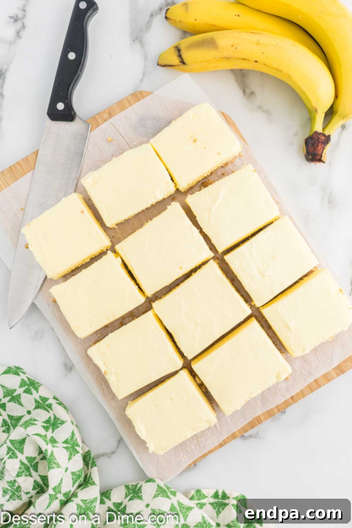 Dreamy Banana Cheesecake Bars 10 The chilled Banana Cream Cheesecake Bars, neatly cut into squares in the baking pan.