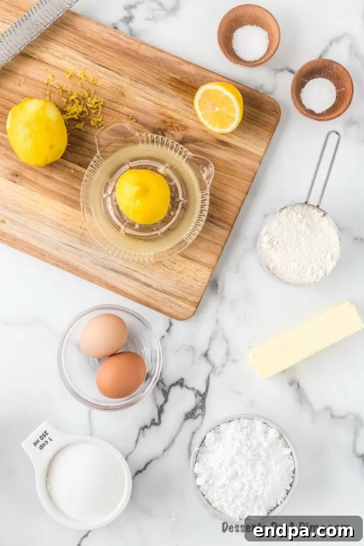 Ingredients for lemon brownies - softened butter, lemon zest, eggs, fresh lemon juice, flour, powdered sugar.