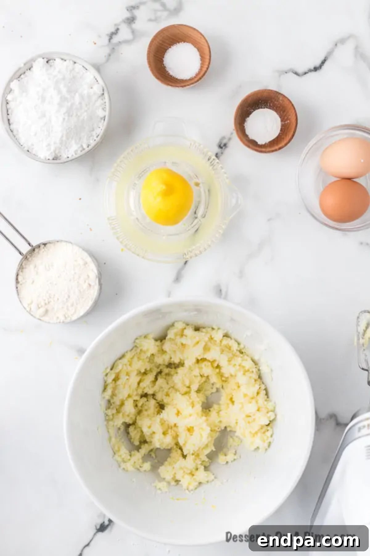 Mixing bowl with softened butter, sugar and lemon zest.