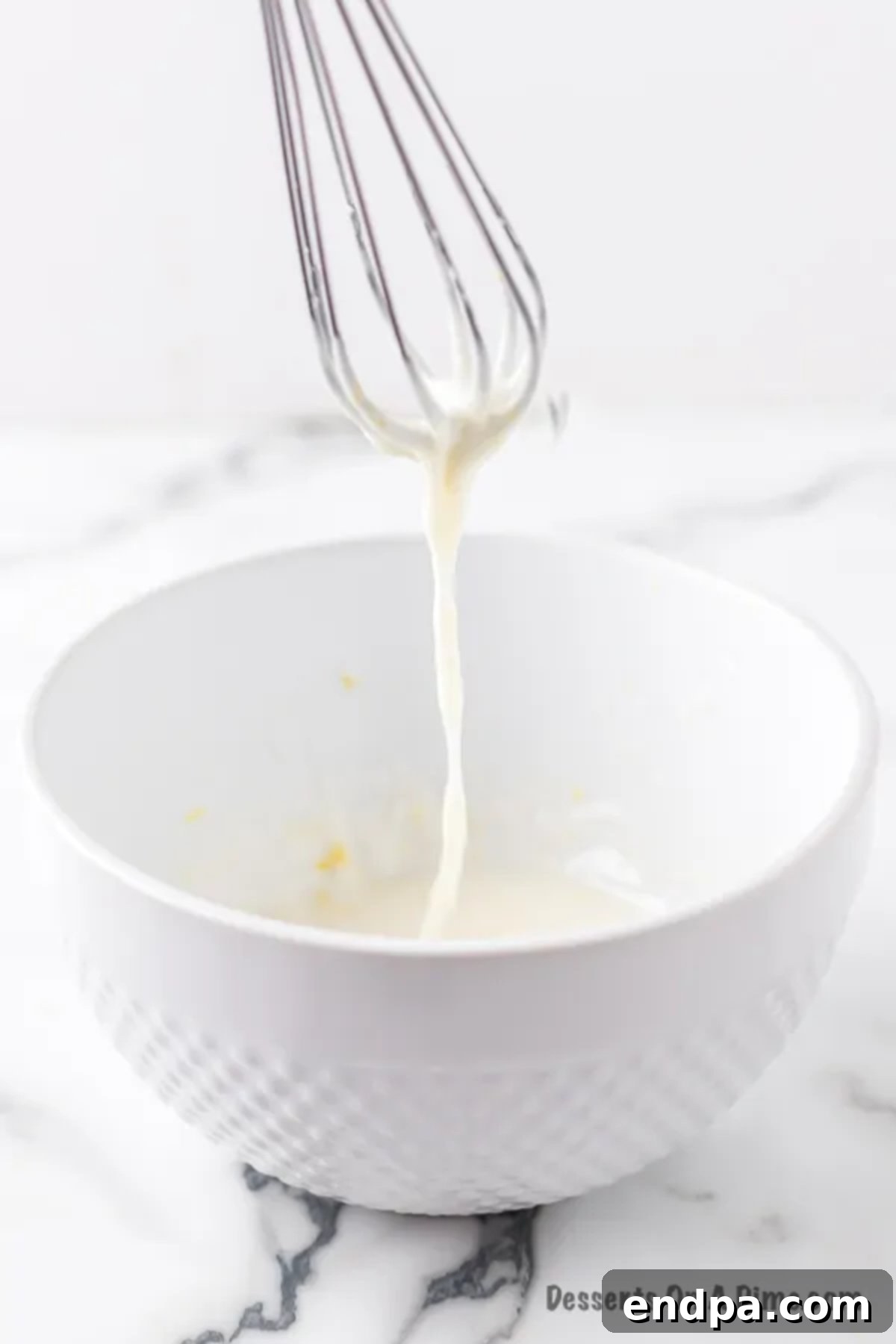 Bowl with powdered sugar, fresh lemon juice, and lemon zest for the glaze.