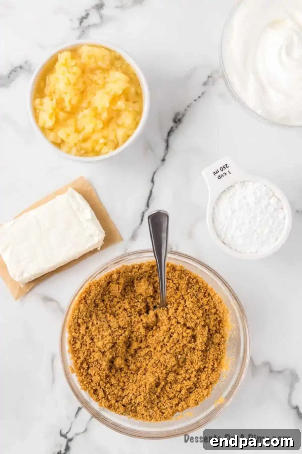 Graham cracker crumbs in a bowl, thoroughly combined with melted butter.