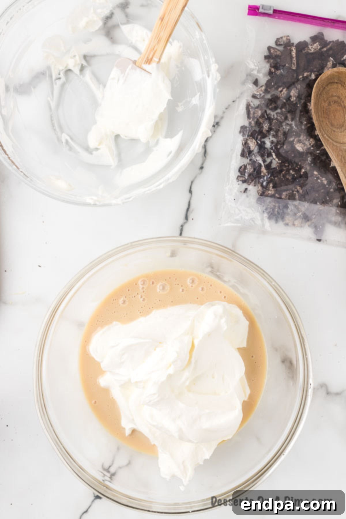 Midnight Cookie Swirl Ice Cream 7 Sweetened condensed milk mixture being gently folded into whipped cream.