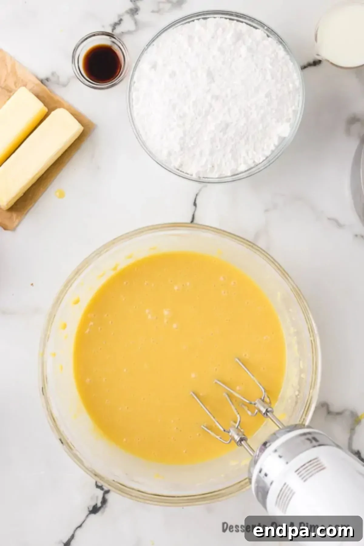 A bowl filled with smooth, pale cake batter, ready for baking.