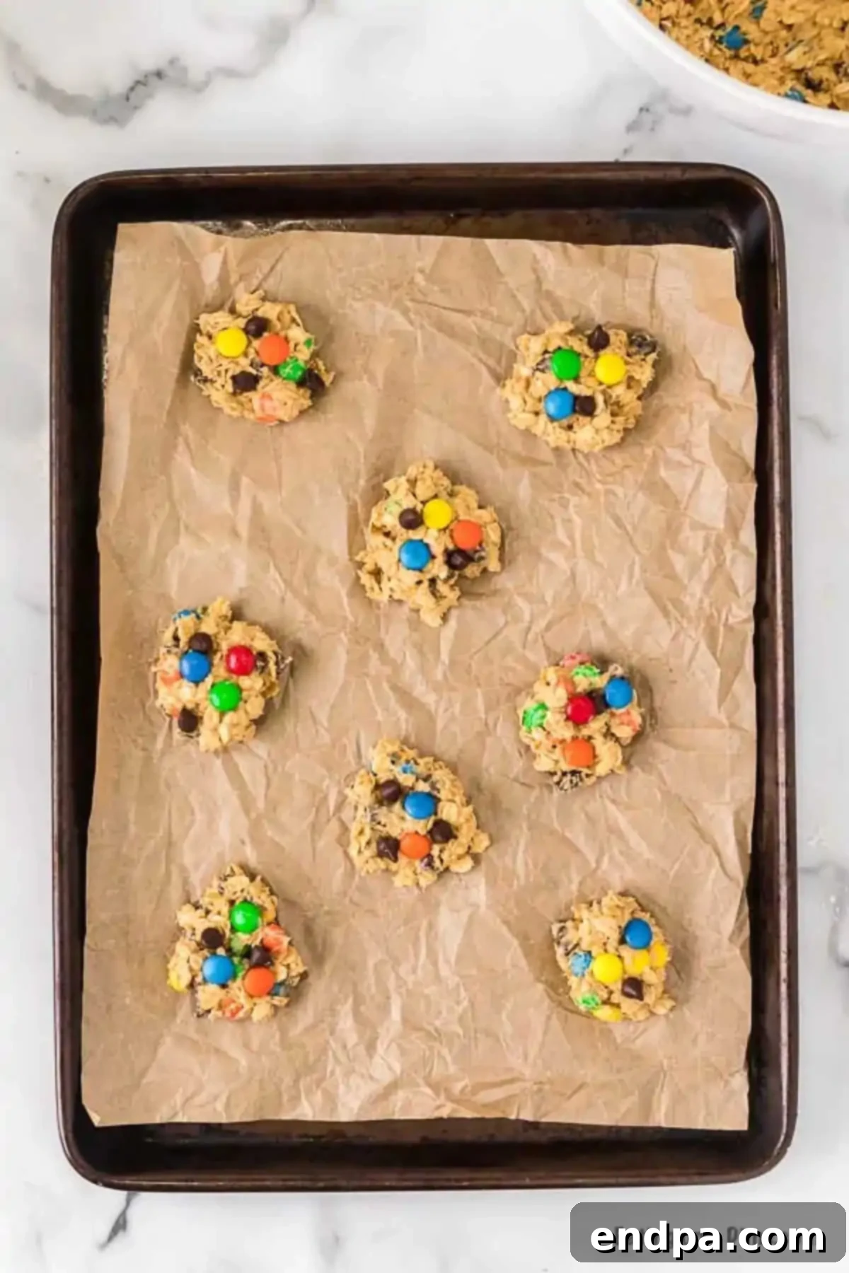 Cookie dough balls on baking sheet.