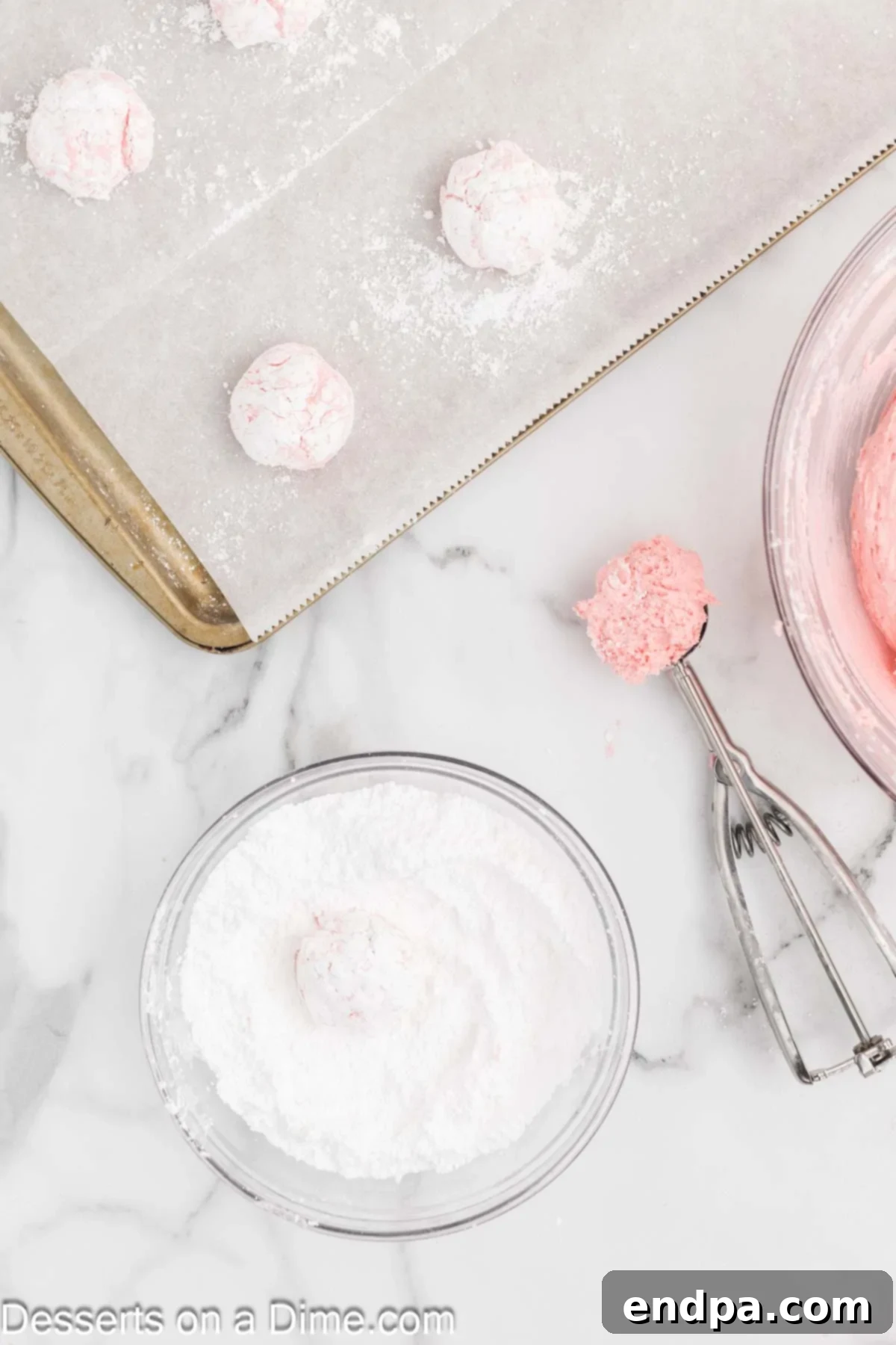 Dough balls dropped into powdered sugar, ready for coating.