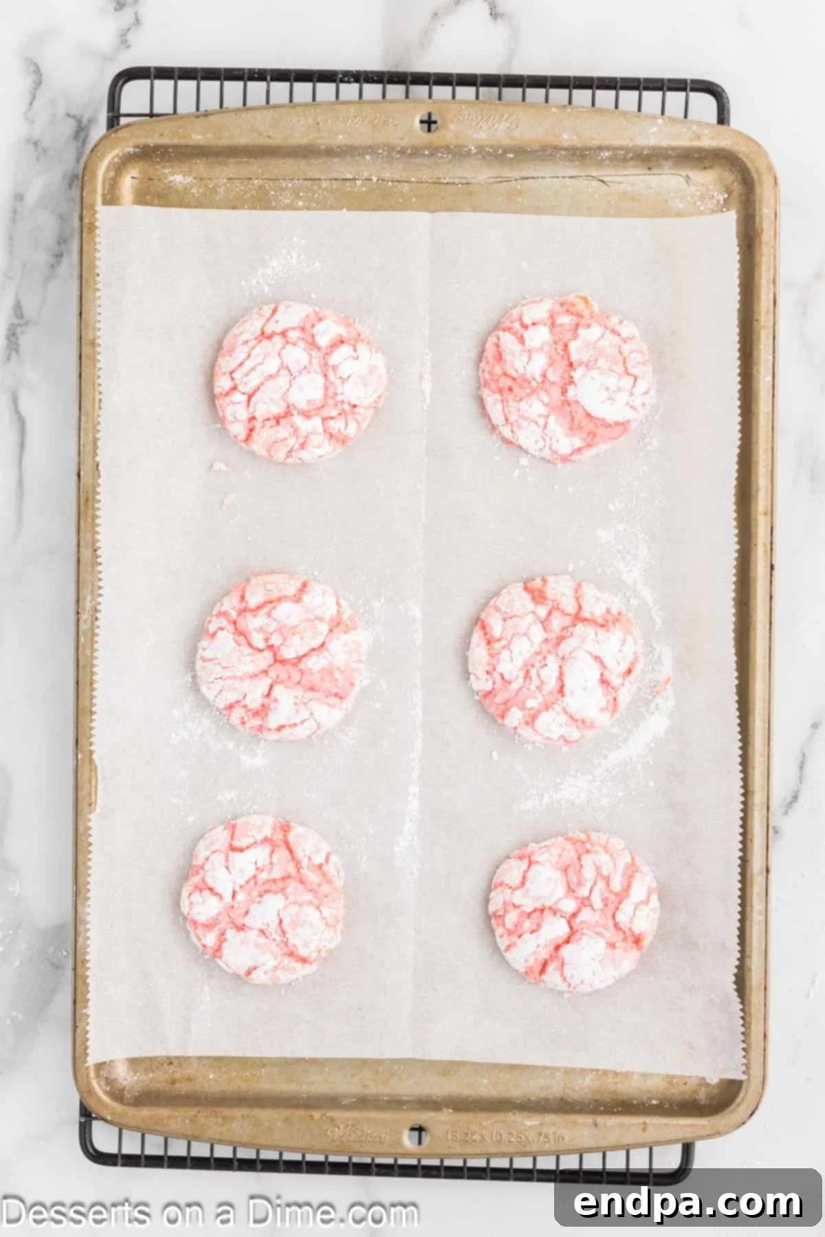 Cookies cooling on baking sheet, showing their crinkled tops.