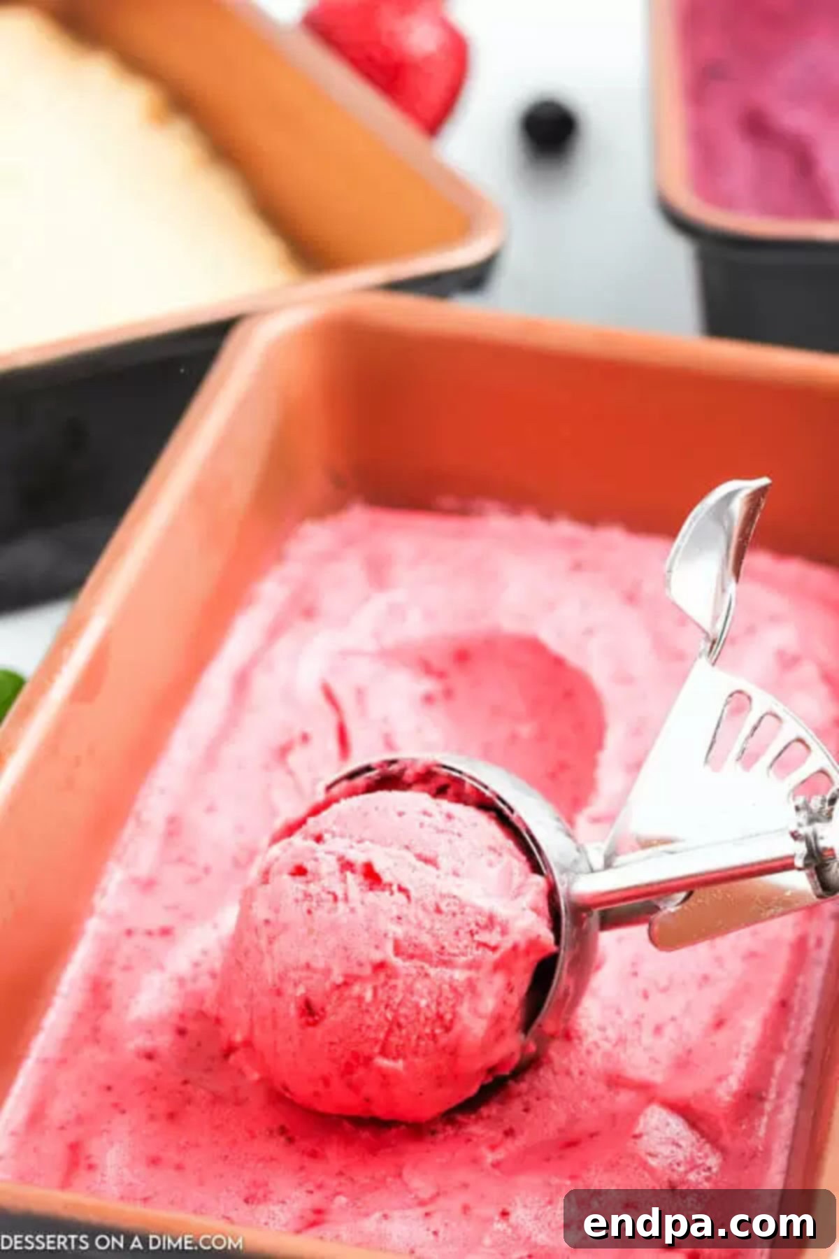 Cool & Creamy Homemade Frozen Yogurt 4 A bowl of frozen fruit being added to a food processor with yogurt and honey, illustrating the first step.