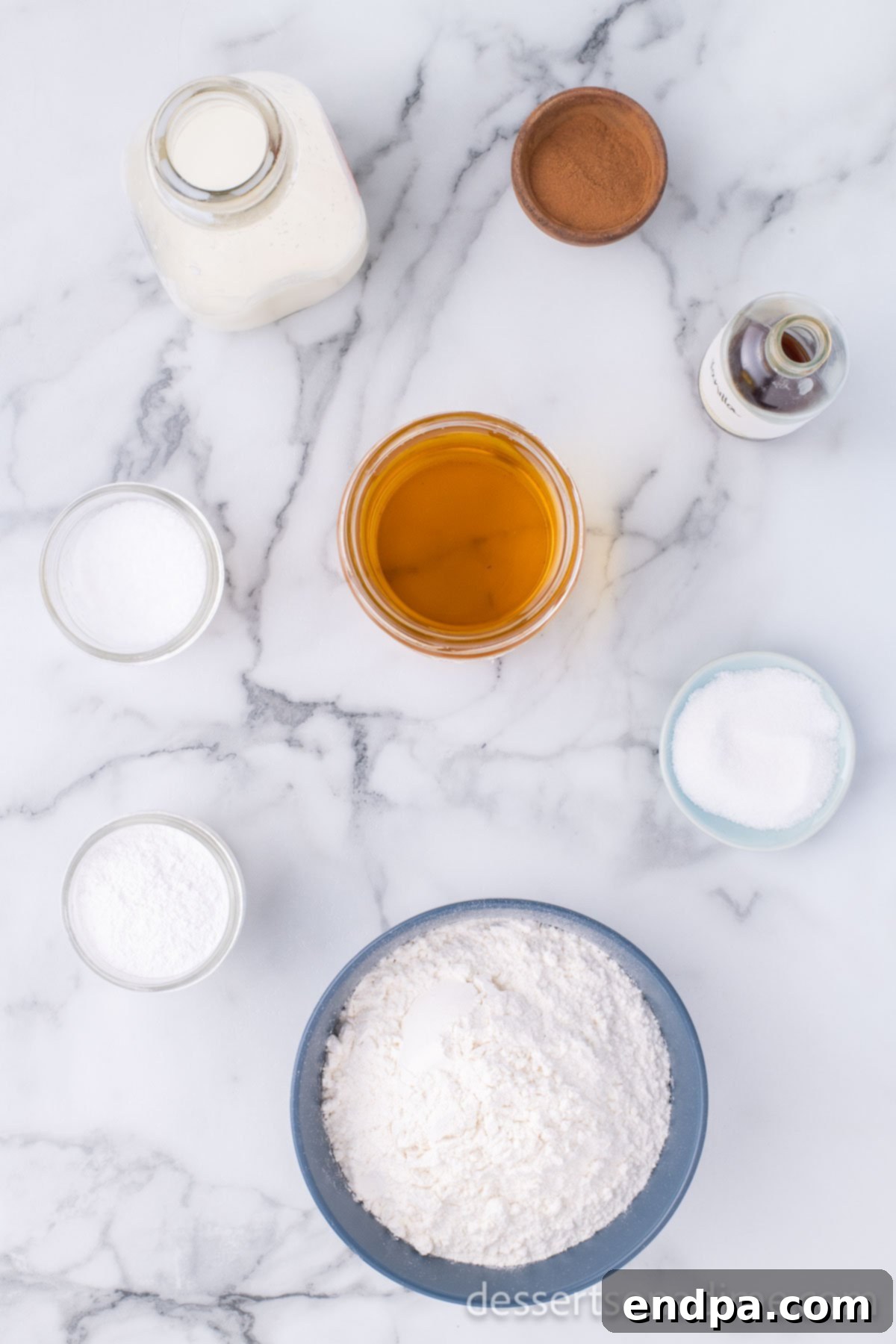 Golden Crispy Elephant Ears Delight 3 A flat lay showing all the simple ingredients required to make Elephant Ears: all-purpose flour, salt, baking powder, whole milk, frying oil, granulated sugar, and ground cinnamon.