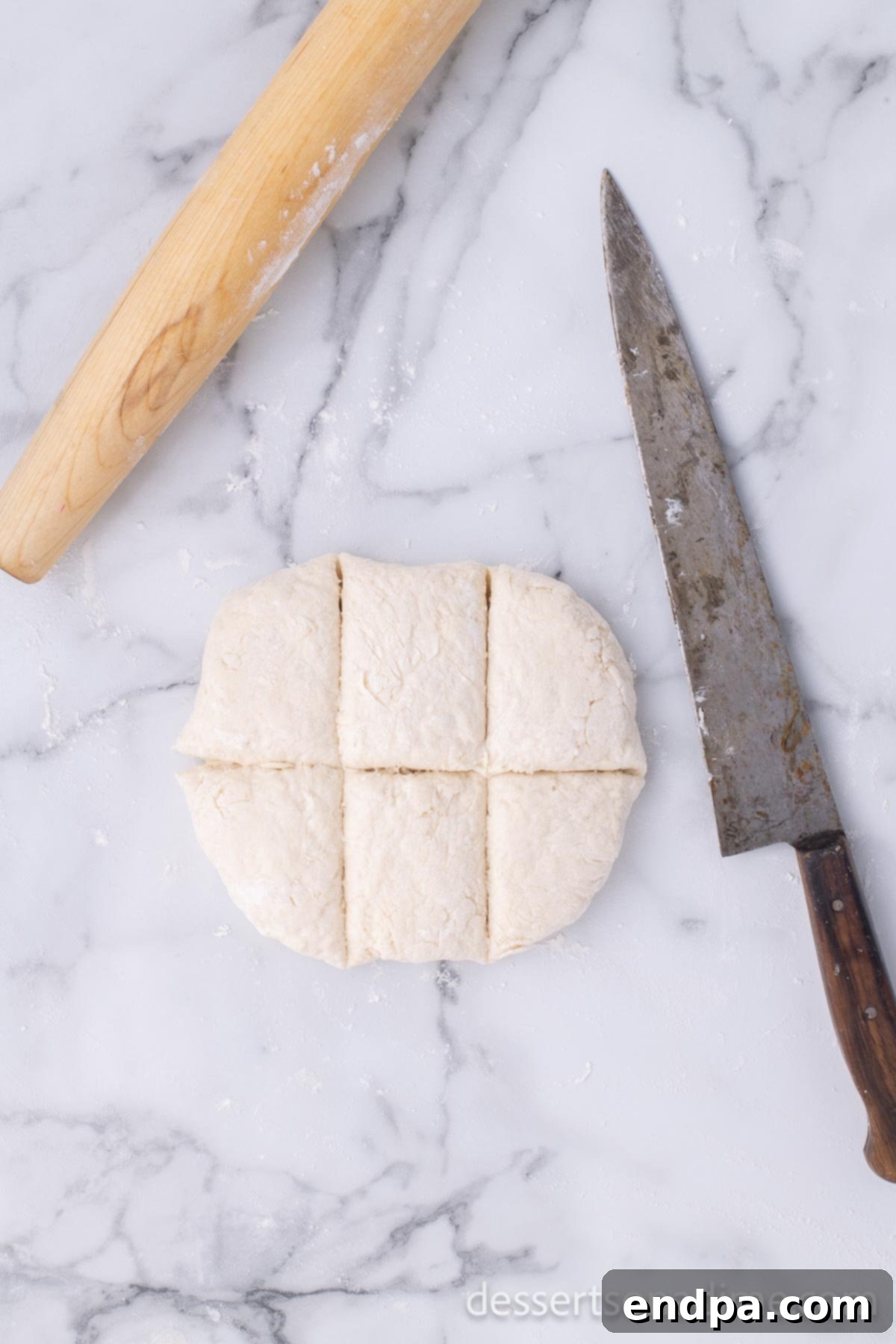 Golden Crispy Elephant Ears Delight 7 A flattened dough disc is carefully cut into six even sections using a sharp knife or dough cutter.
