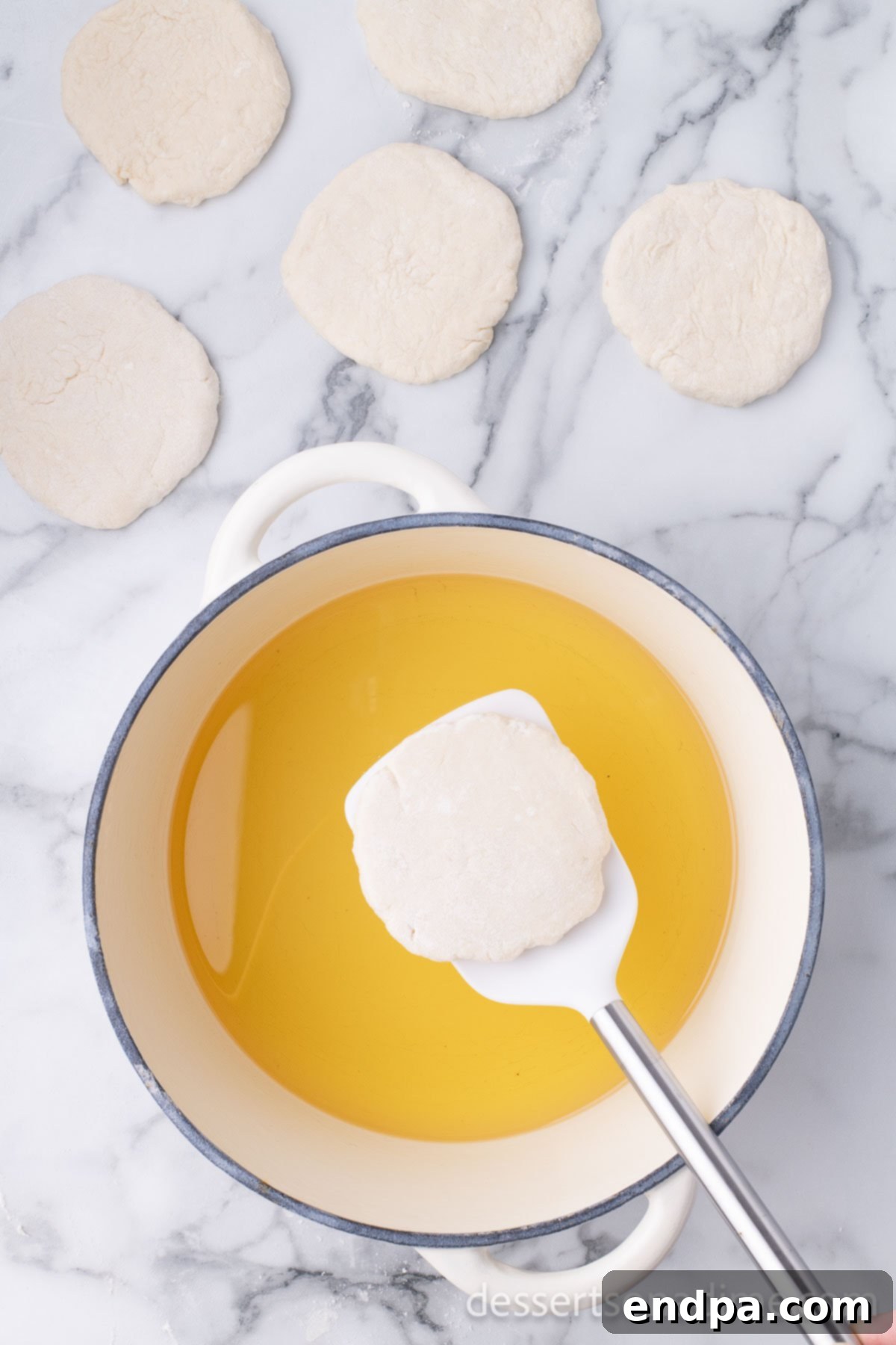 Golden Crispy Elephant Ears Delight 9 A deep pot on the stove contains about three inches of hot oil, heated to 375 degrees Fahrenheit, ready for frying the dough.