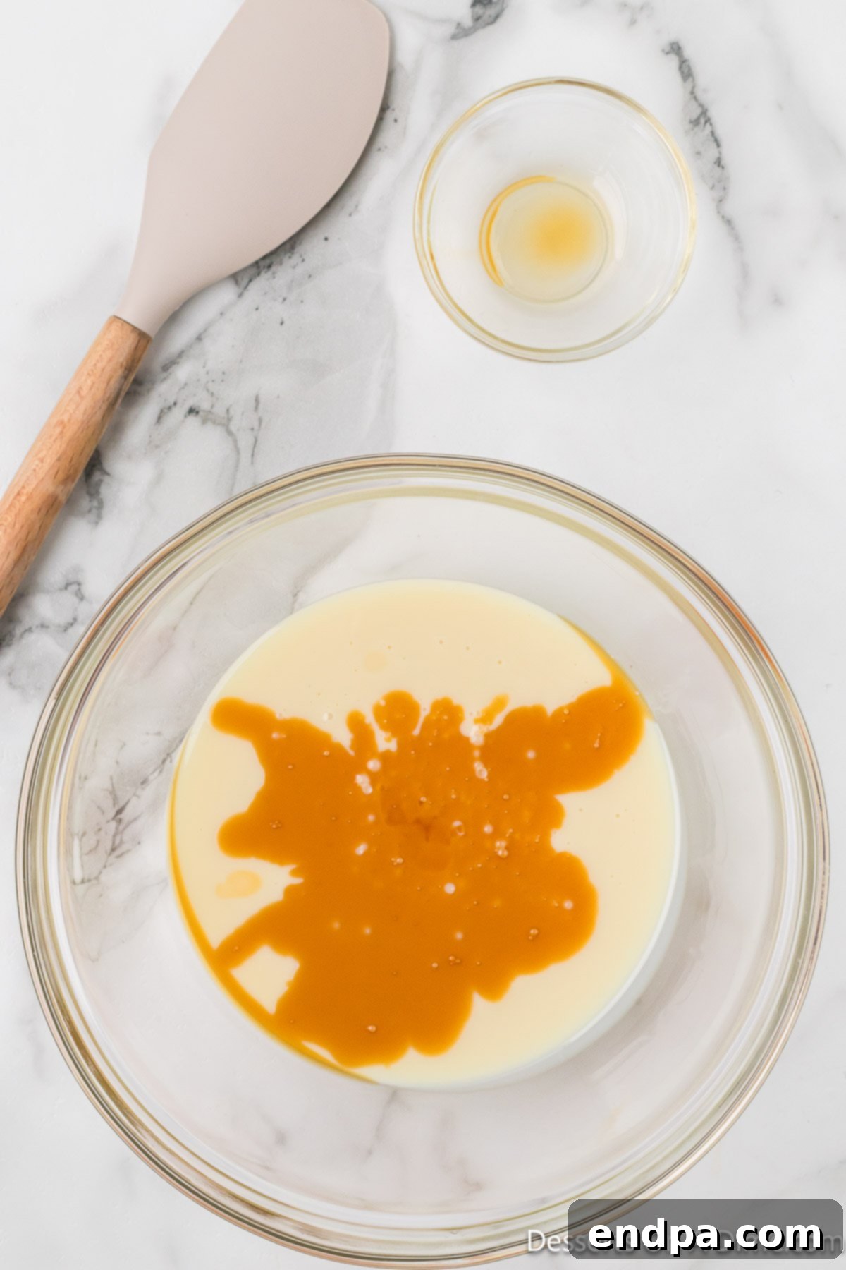 Mixing bowl with sweetened condensed milk and vanilla. 