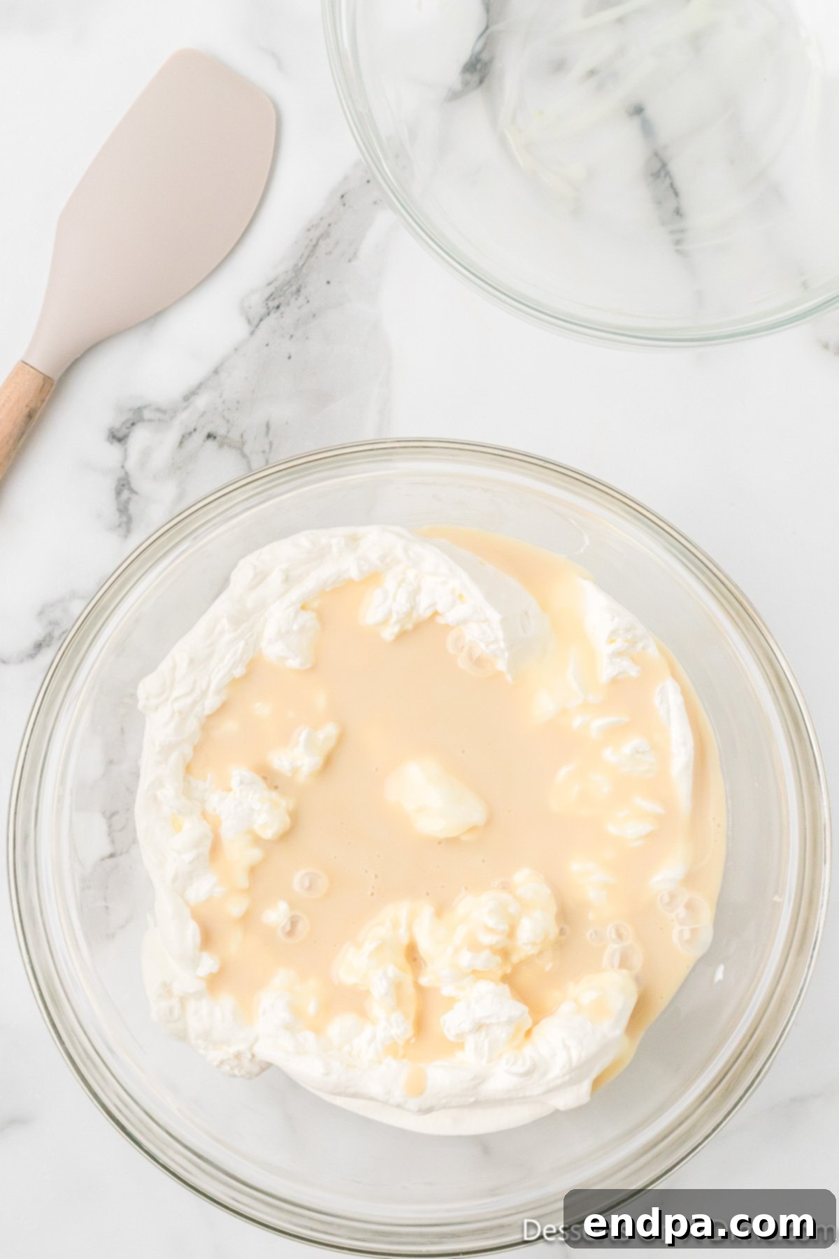 Sweetened condensed milk mixed into whipped cream mixture. 