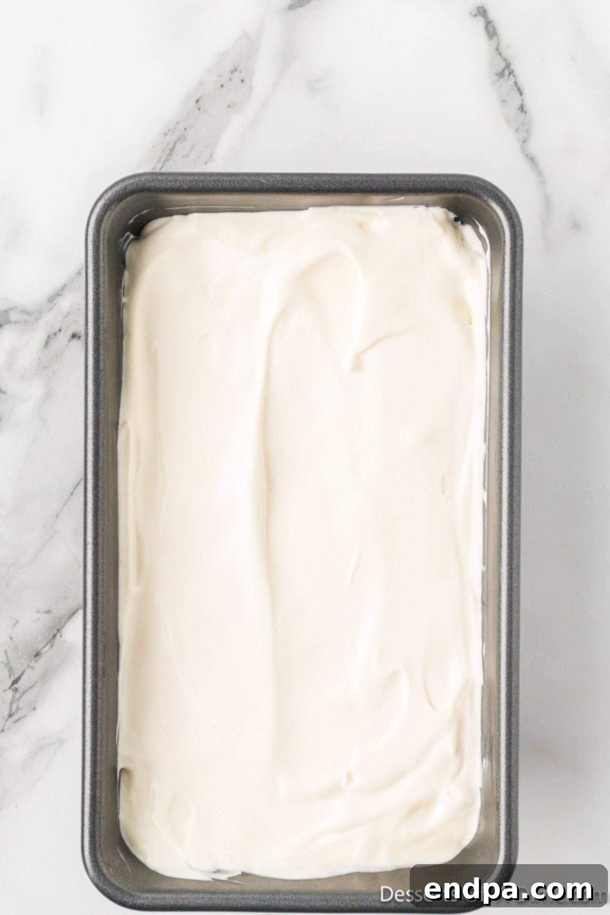 Ice Cream mixture spread into loaf pan. 