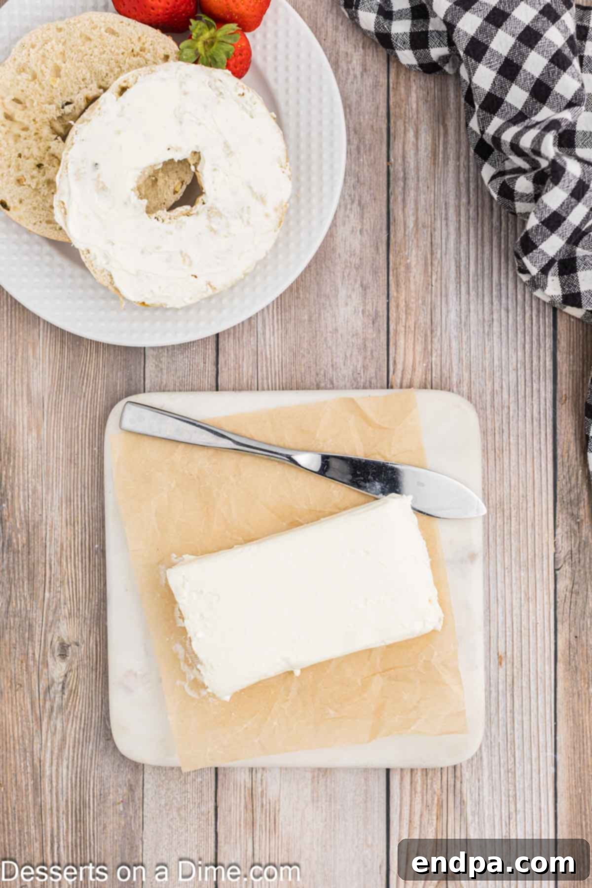 Effortless Ways to Soften Cream Cheese 2 Block of cream cheese on parchment paper, ready to be softened.
