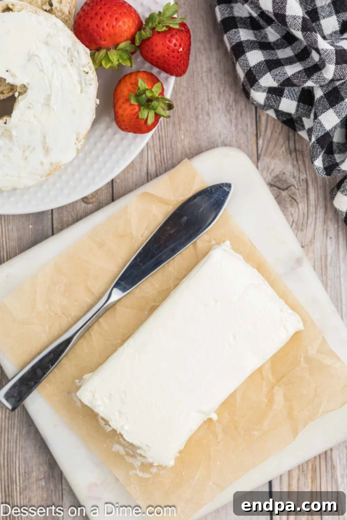 Effortless Ways to Soften Cream Cheese 8 Perfectly softened cream cheese on parchment paper, showcasing its smooth, spreadable texture.