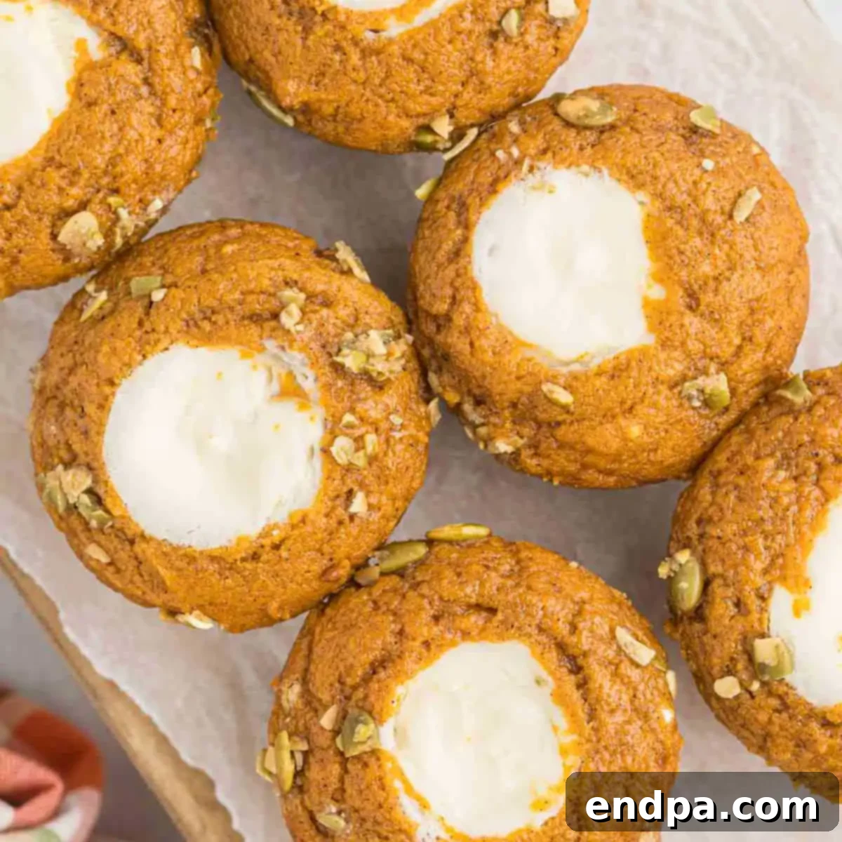 Starbucks-Style Pumpkin Spice Cream Cheese Muffins 15 Starbucks Cream Cheese Muffins arranged on a platter, showcasing their golden tops and creamy centers.