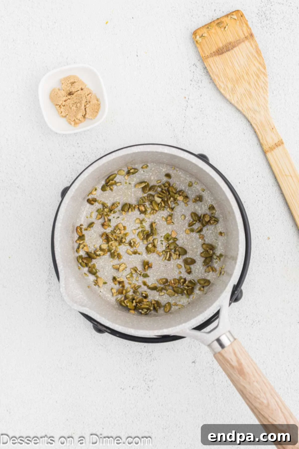 Starbucks-Style Pumpkin Spice Cream Cheese Muffins 4 Pumpkin seeds sautéing in a small saucepan with melted butter and brown sugar.
