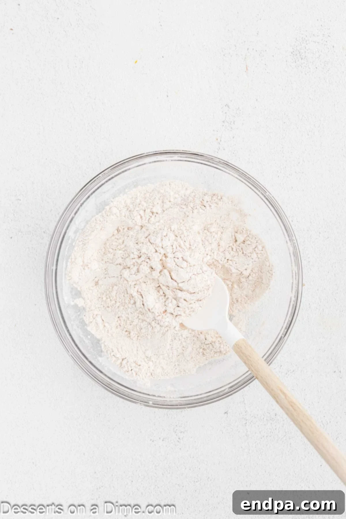 Starbucks-Style Pumpkin Spice Cream Cheese Muffins 5 Dry muffin ingredients (flour, pumpkin pie spice, salt, baking soda, baking powder) combined in a mixing bowl.