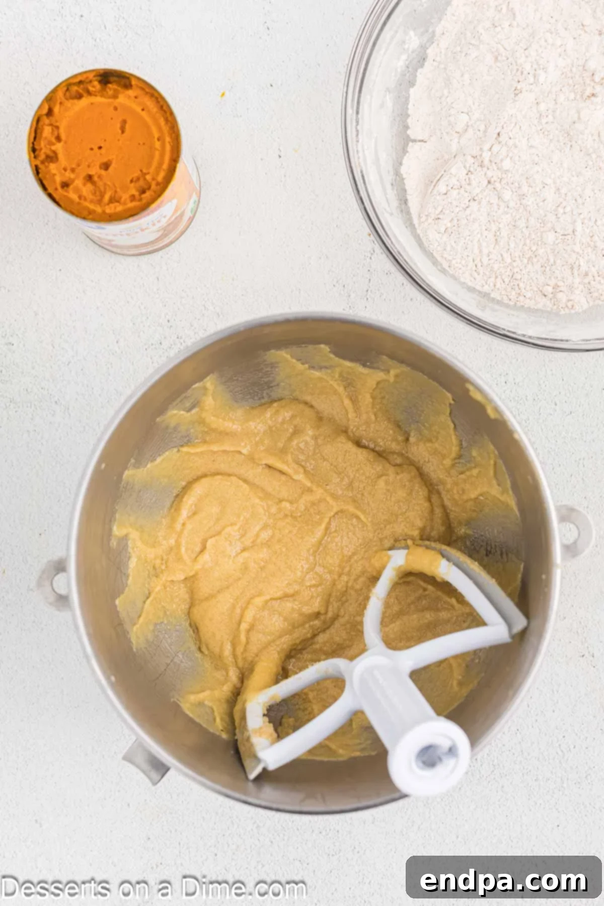Starbucks-Style Pumpkin Spice Cream Cheese Muffins 7 Eggs being added to the creamed butter and sugar mixture in a stand mixer.