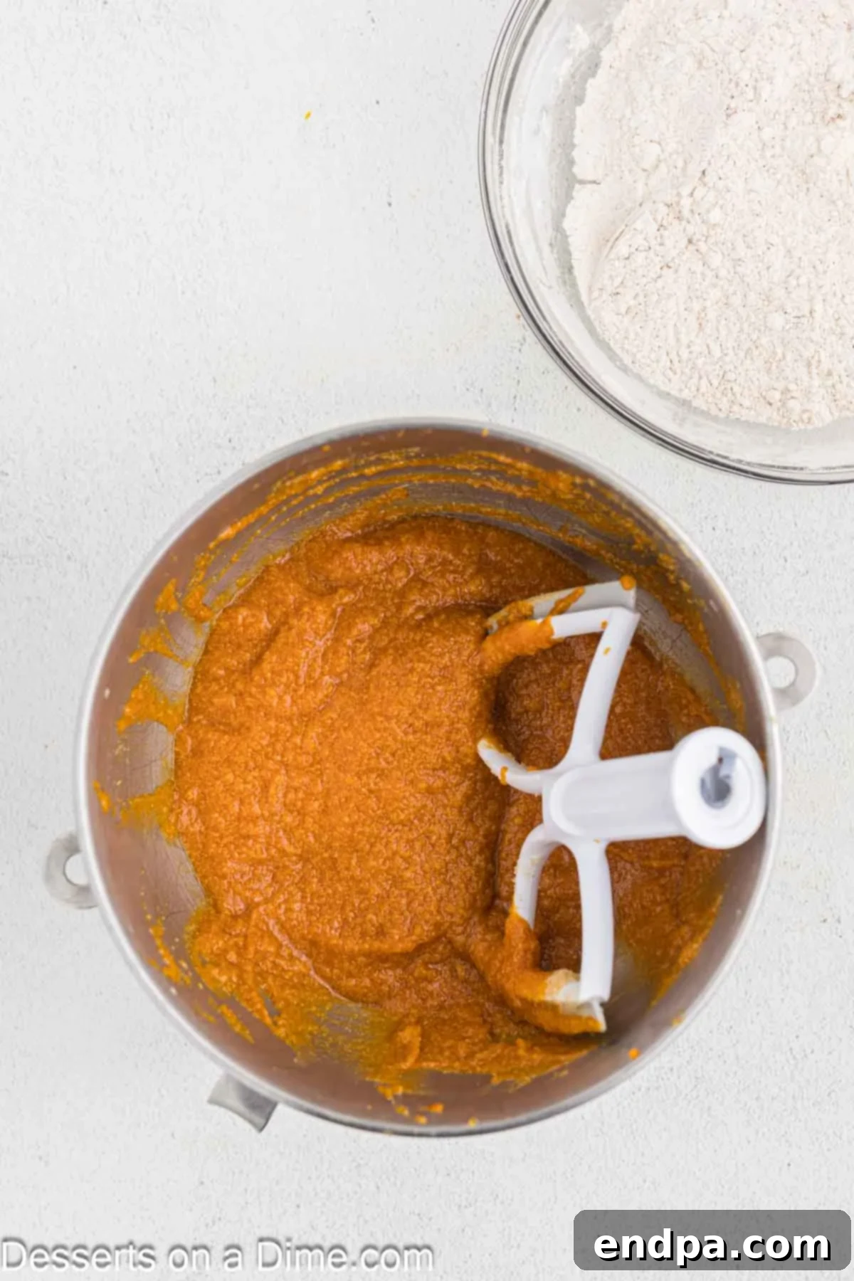 Starbucks-Style Pumpkin Spice Cream Cheese Muffins 8 Canned pumpkin puree being mixed into the wet ingredients in a stand mixer.