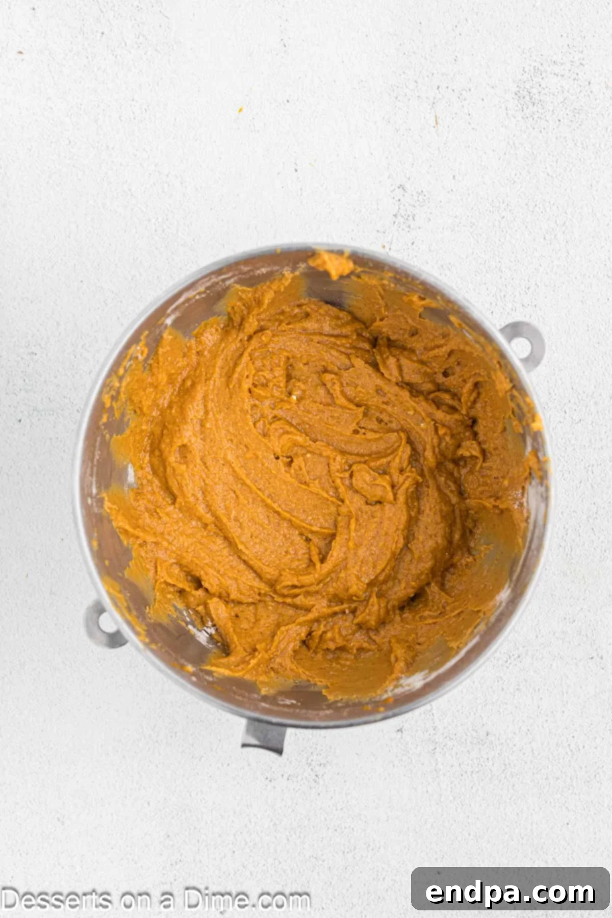 Starbucks-Style Pumpkin Spice Cream Cheese Muffins 9 Dry and wet muffin ingredients being gently combined in a large mixing bowl.