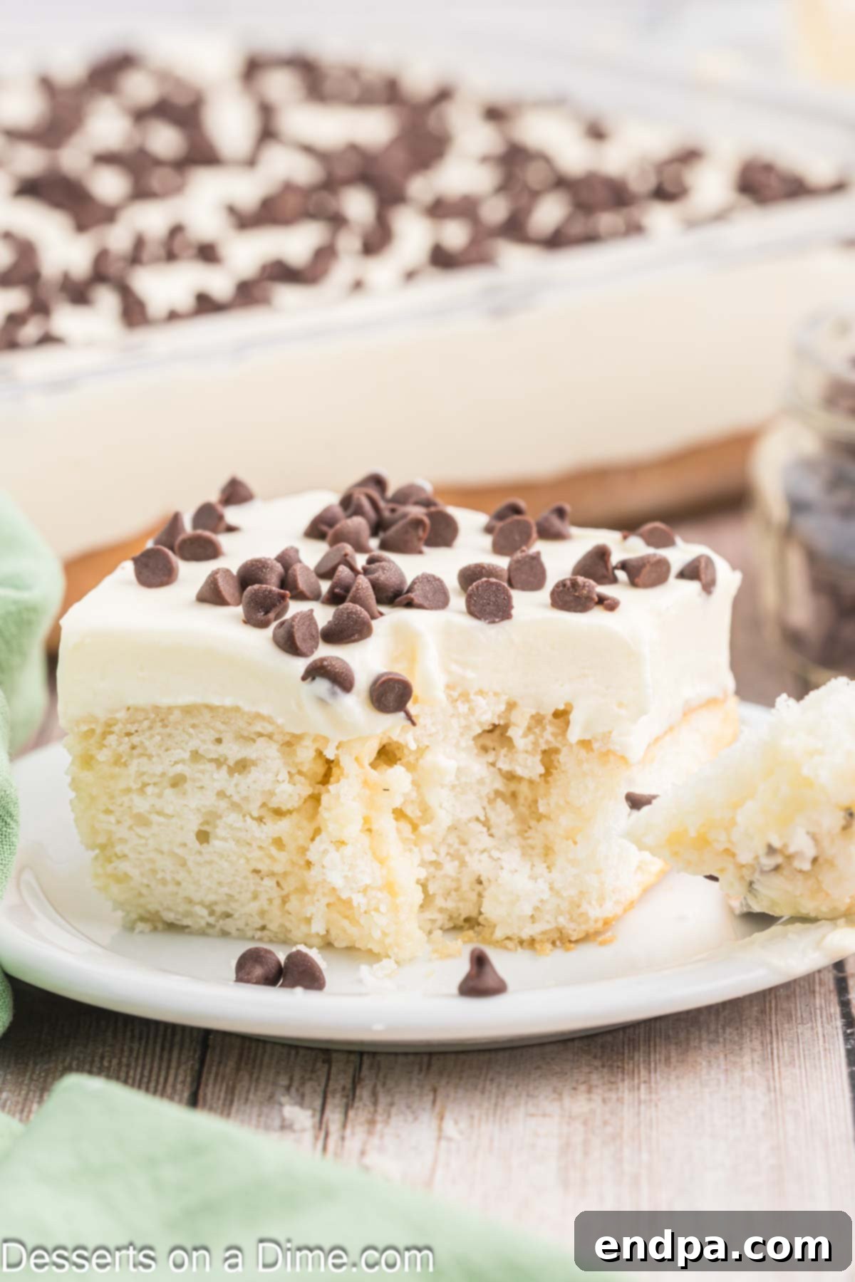 Slice of Cannoli Poke Cake on a plate.