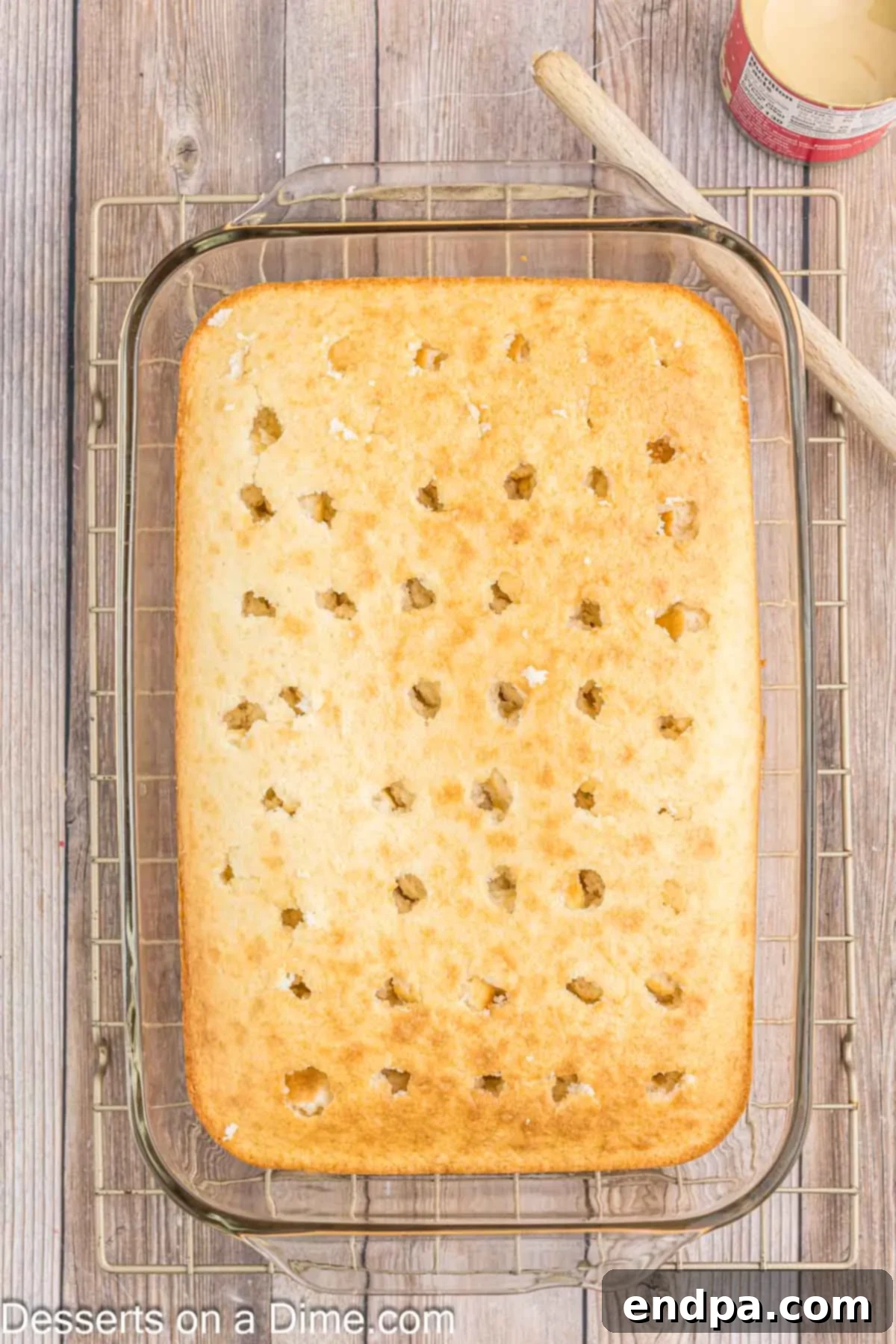 Cake baked and poked with holes.