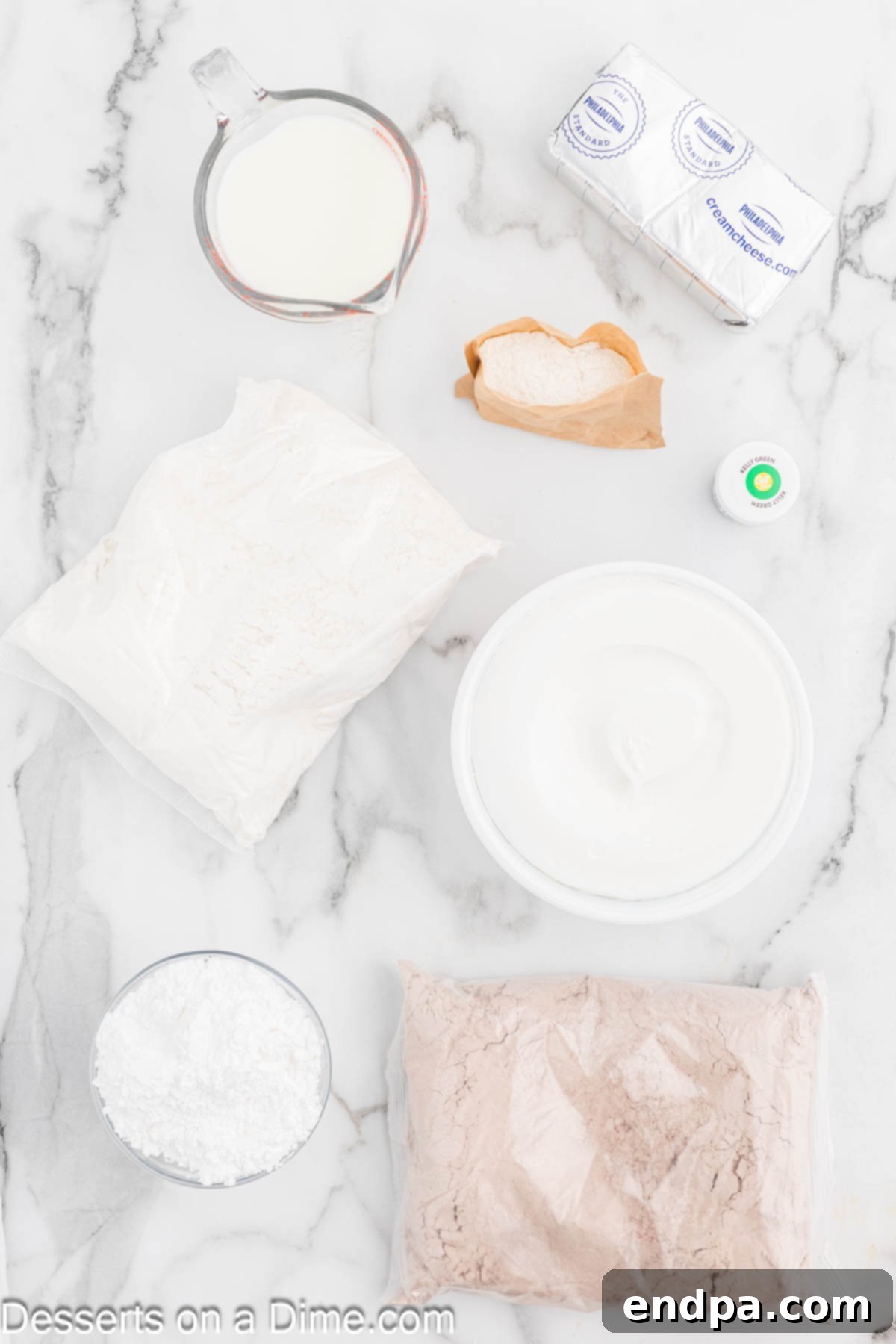 Ingredients for Christmas Trifle laid out: white cake mix, red velvet cake mix, green food coloring, white chocolate pudding mix, cold milk, cream cheese, powdered sugar, cool whip.