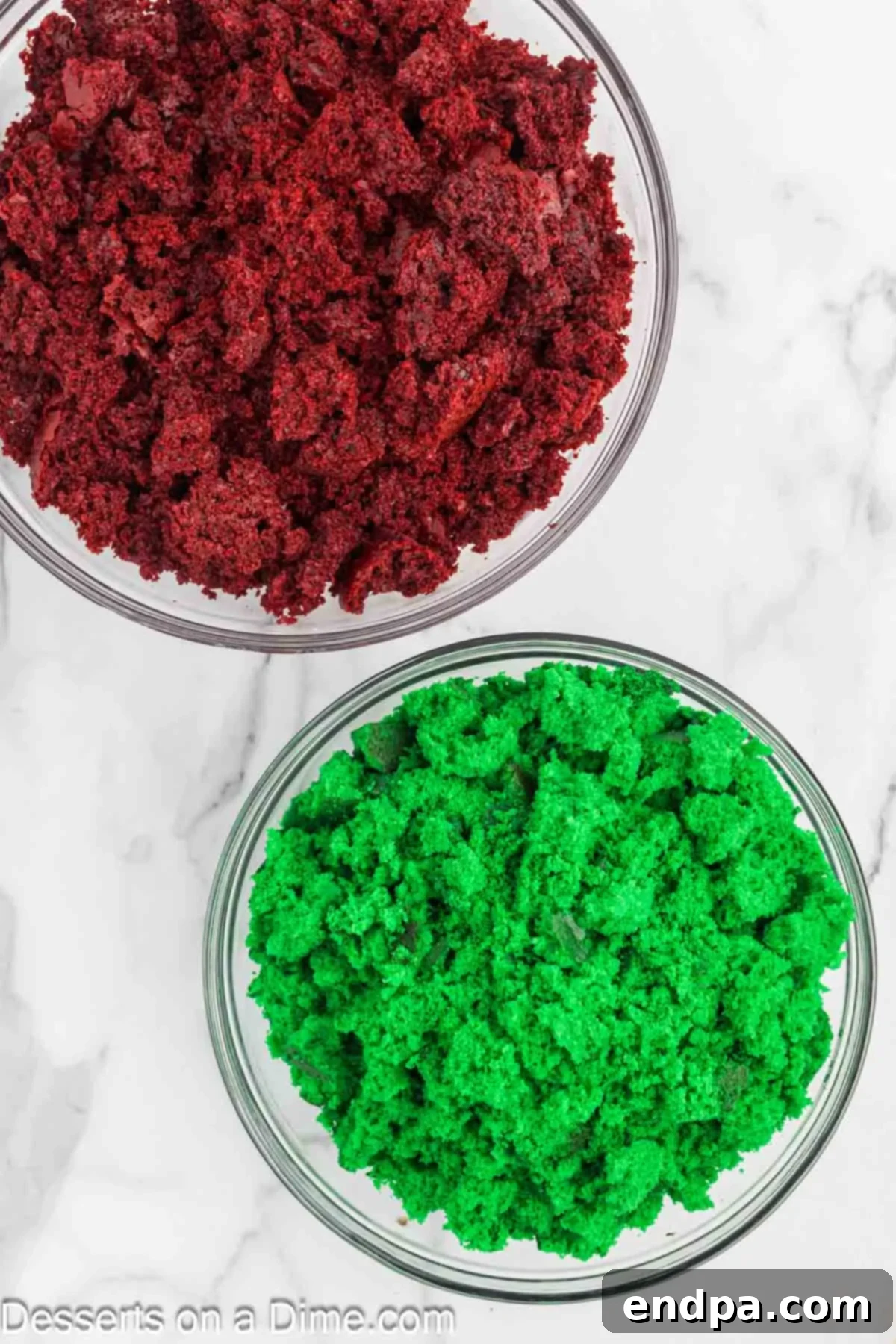 Cake crumbs in separate bowls, one red and one green.