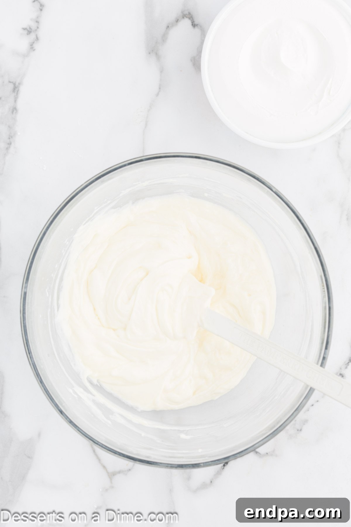 Pudding and cream cheese mixture combined together in a bowl, then folded with whipped cream.