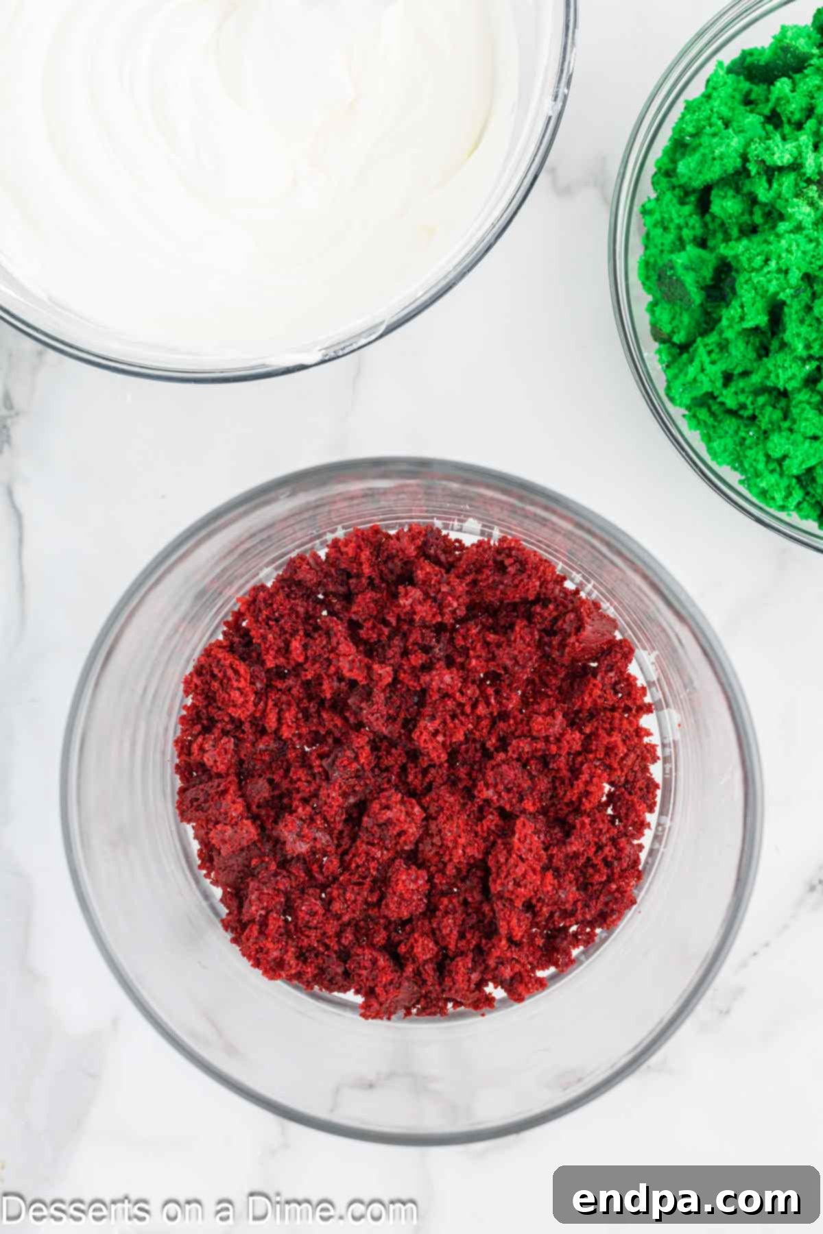 First layer of red velvet cake crumbs placed into a trifle dish.