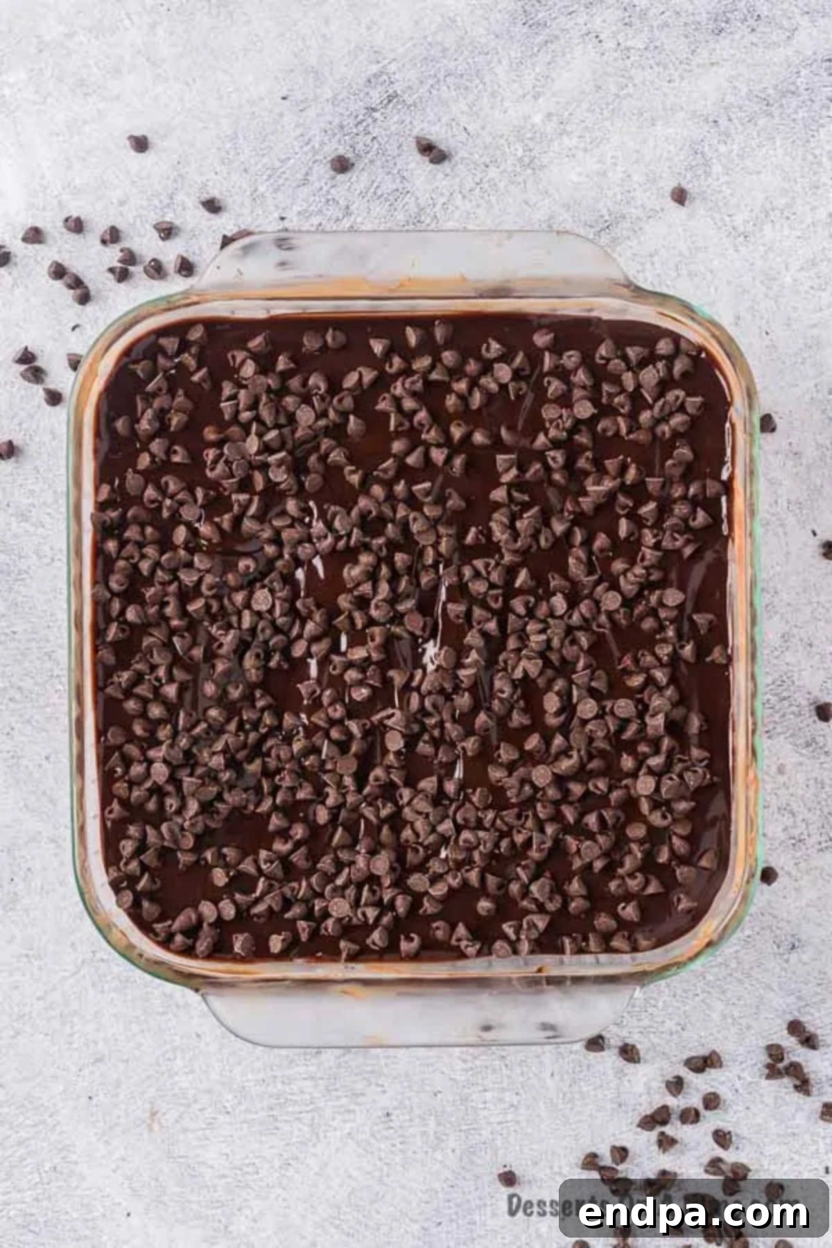 Finished chocolate icebox cake with ganache poured over it and mini chocolate chips sprinkled on top.