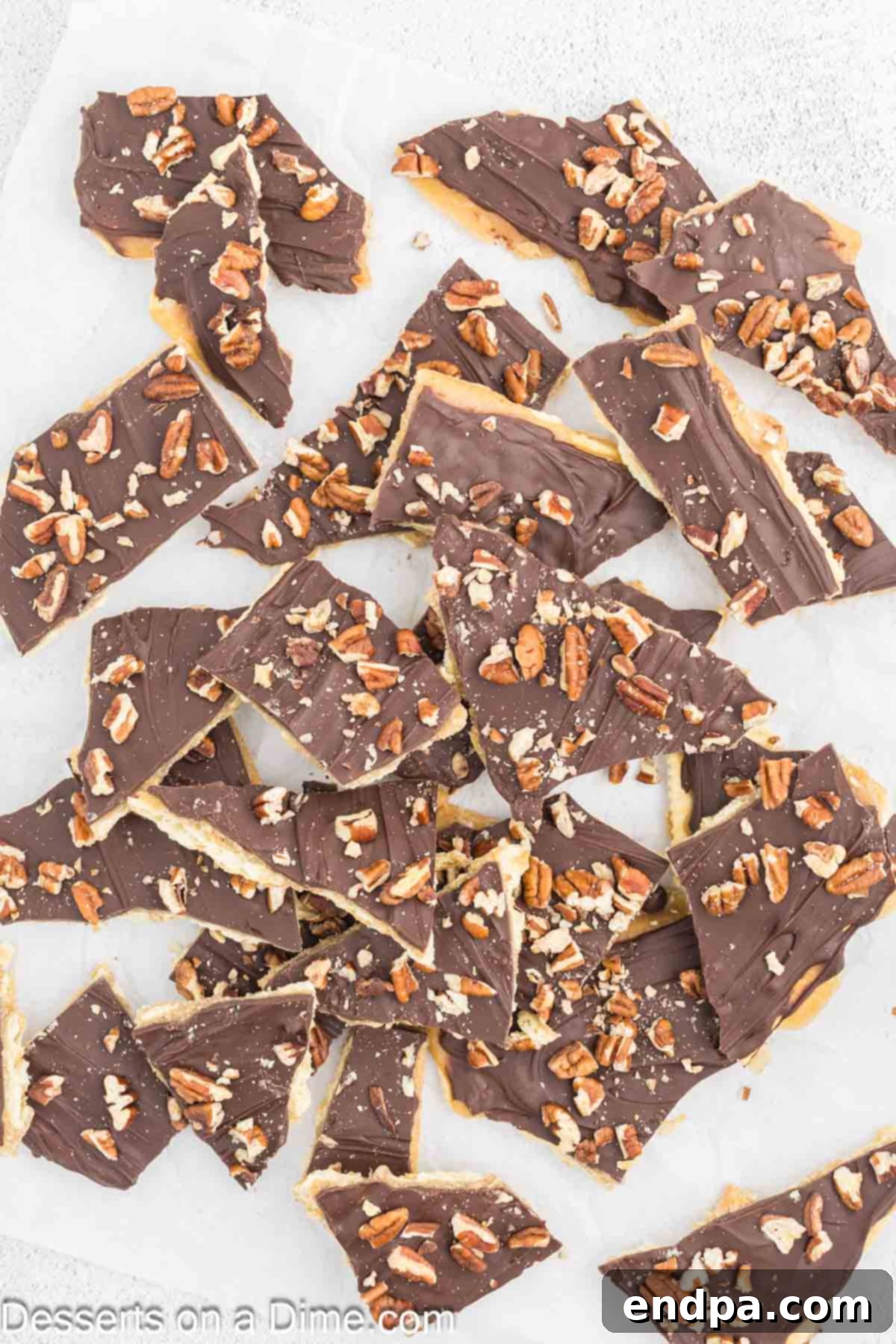 Sweet and Salty Toffee Bark 10 The finished Saltine Cracker Toffee, broken into irregular pieces, arranged invitingly on a white surface.