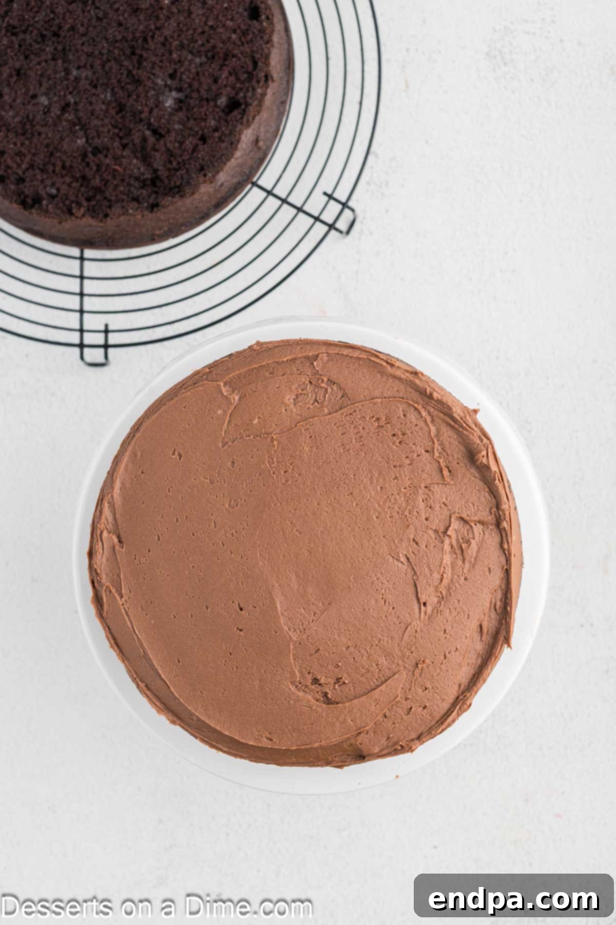 Festive Turkey Cake 11 Cake topped with first layer of chocolate frosting.