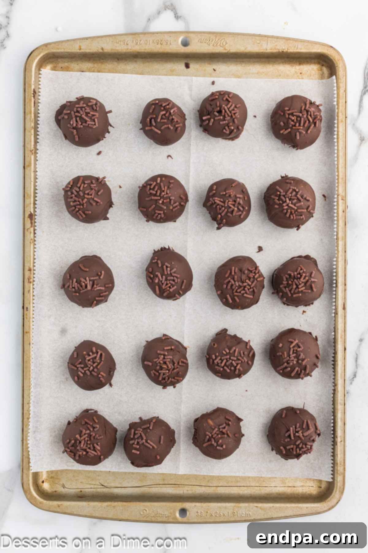 Fudgy Brownie Bonbons 9 Truffles on baking sheet topped with sprinkles.