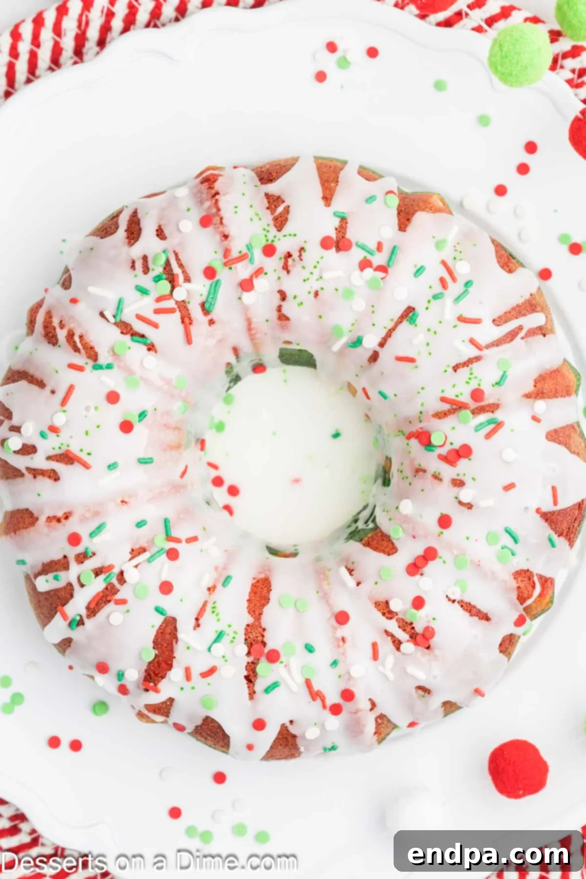 Cooled Christmas Bundt cake with vanilla glaze drizzled over the top.