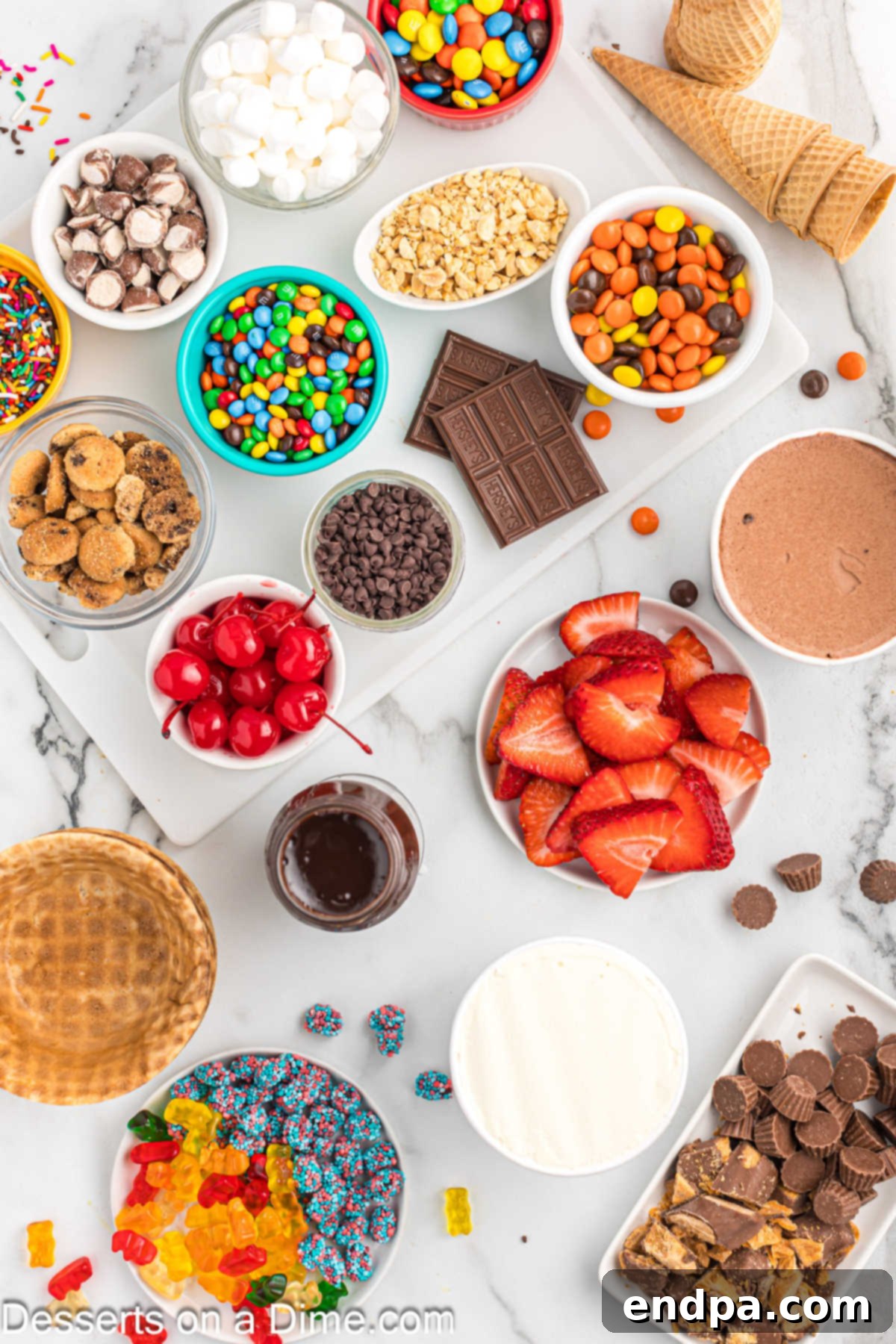 A close-up view of a charcuterie board filled with colorful ingredients like ice cream pints, fresh berries, various candies, crunchy cookies, and dessert sauces.