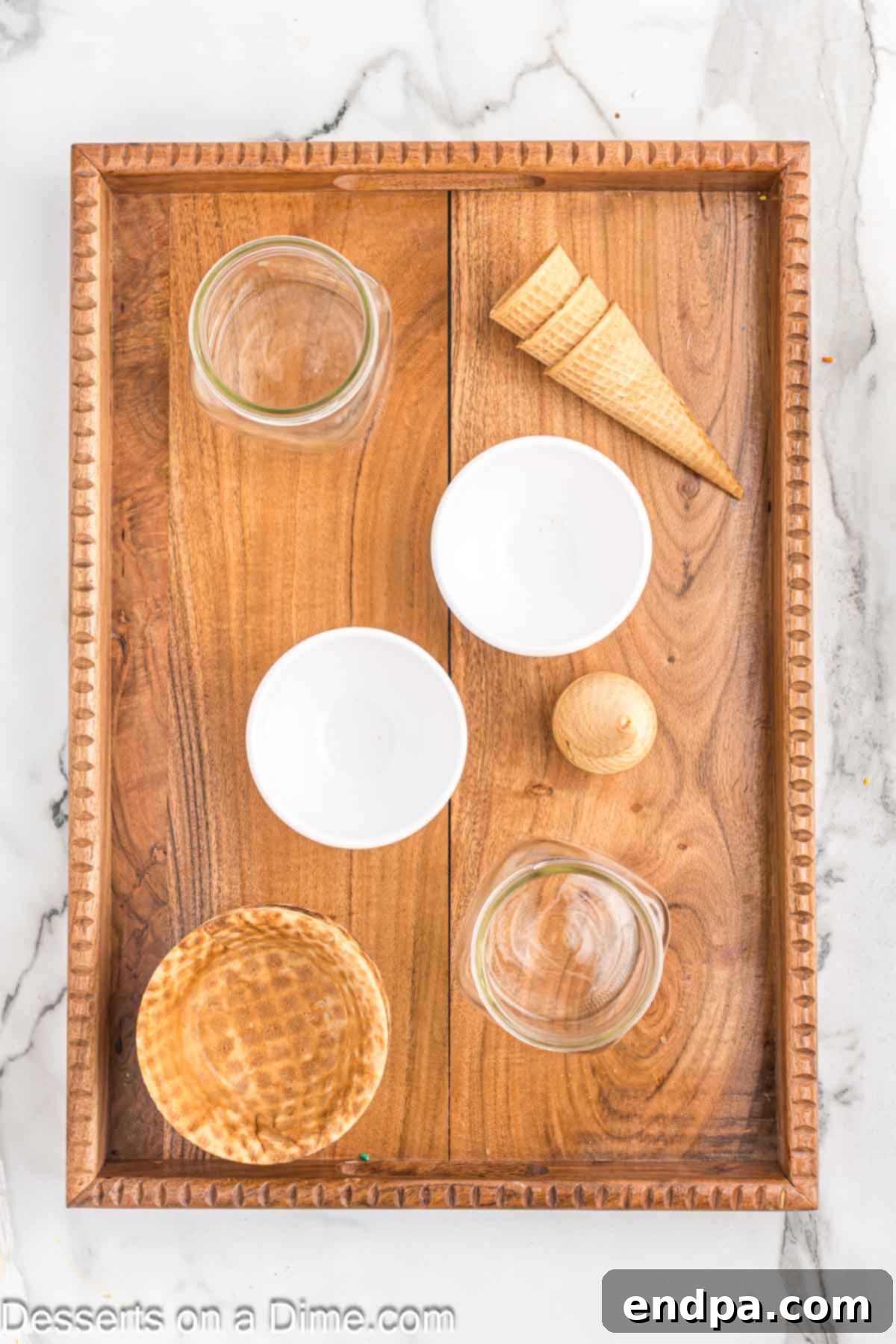 A wooden board with waffle bowls strategically placed to hold ice cream pints.