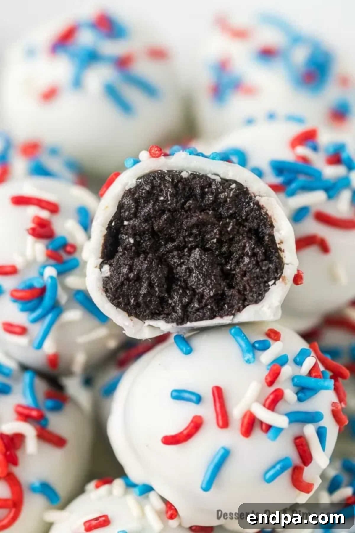 Patriotic Oreo Balls stacked on top of each other. 