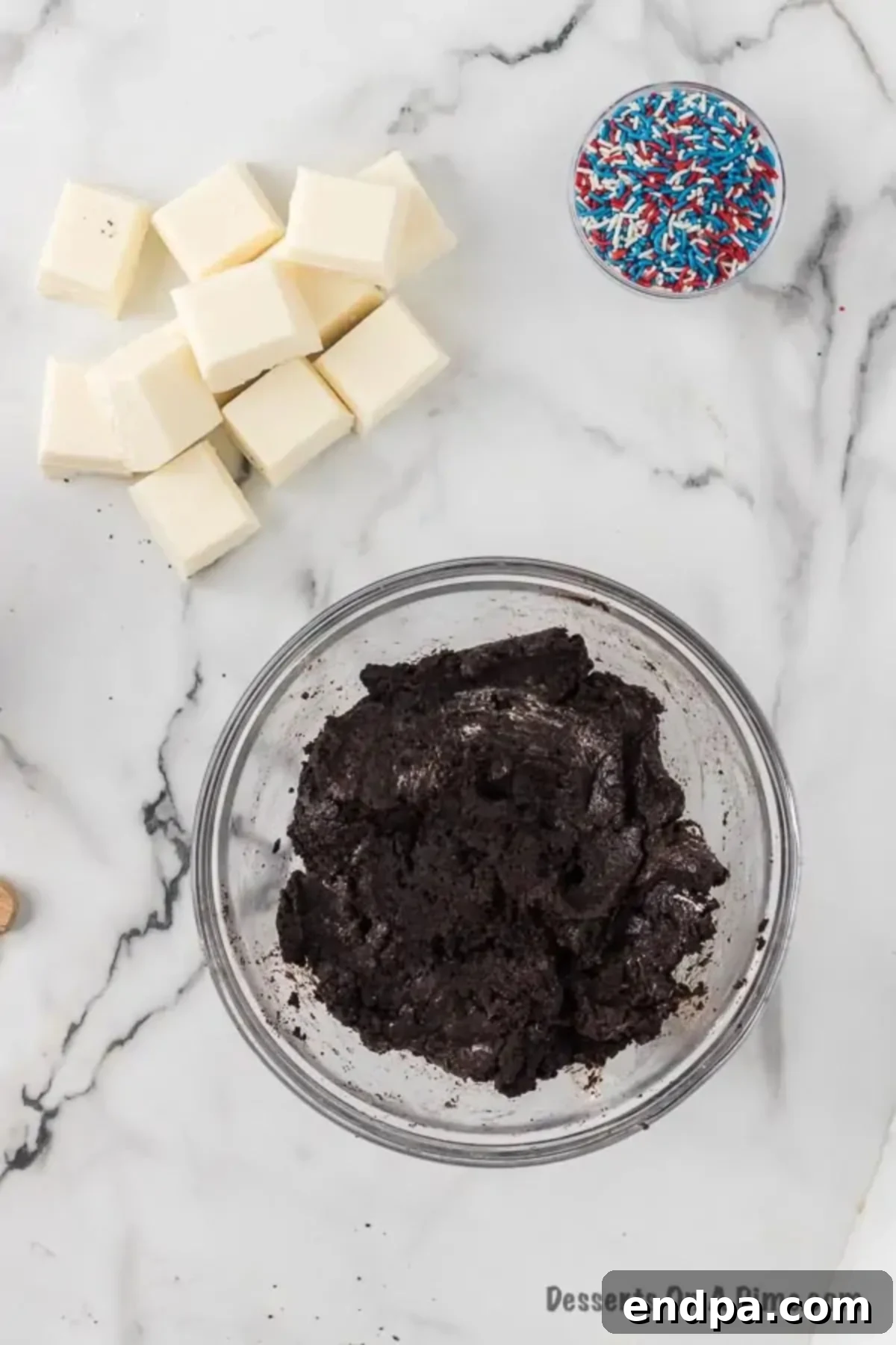 Cookies and cream cheese combined together in a mixing bowl.