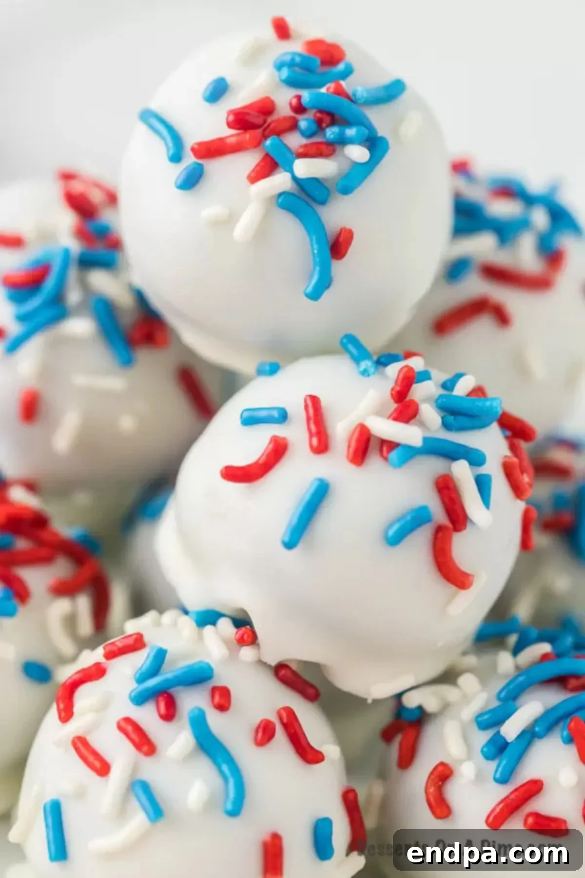 Oreo Balls stacked together and topped with sprinkles. 