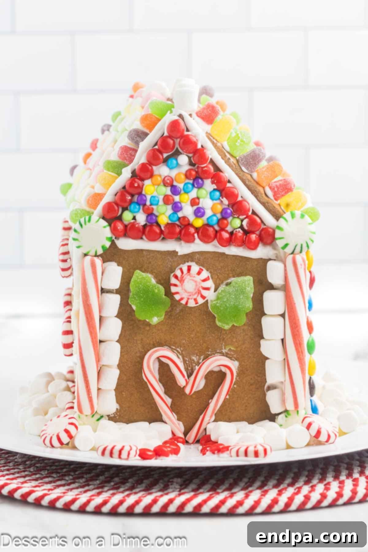 Spiced Sugar Sanctuary 2 A beautifully decorated gingerbread house placed on a festive platter, ready for the holidays.