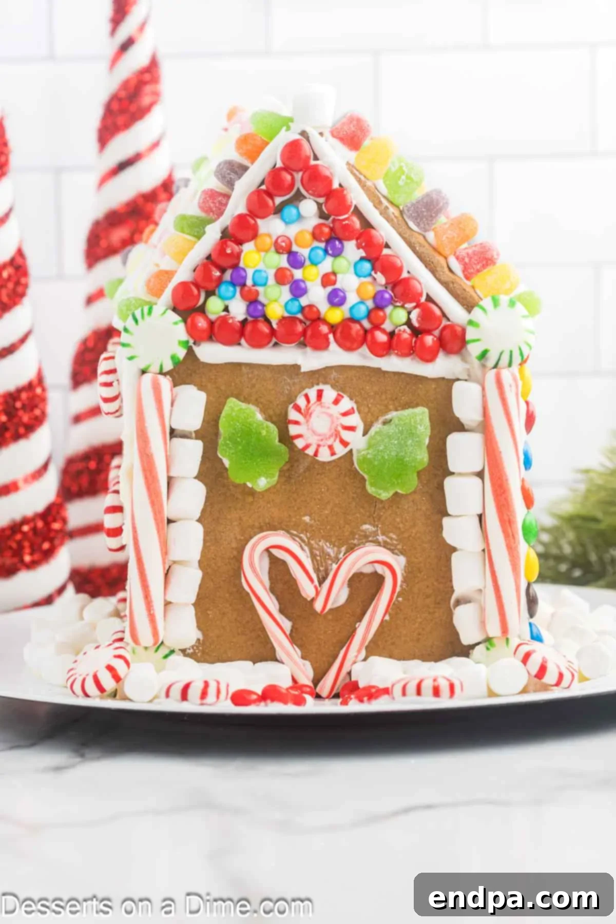 Spiced Sugar Sanctuary 15 A fully decorated gingerbread house adorned with a variety of colorful candies and intricate icing designs, creating a festive holiday display.