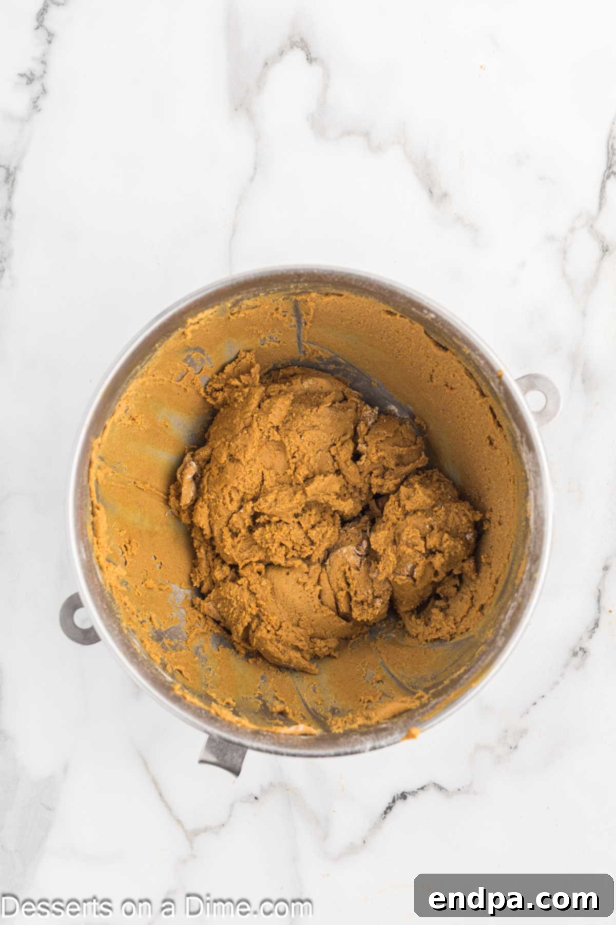 Spiced Sugar Sanctuary 5 Eggs and molasses being added to the creamed butter and sugar mixture, followed by the gradual incorporation of dry ingredients to form the gingerbread dough.