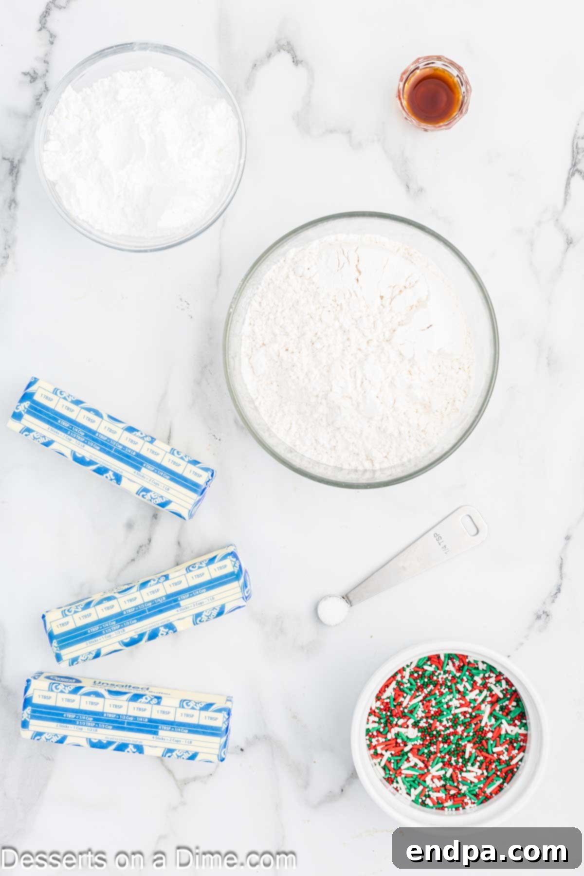 Buttery Christmas Shortbread Delights 3 Ingredients for Shortbread Christmas Cookies including flour, powdered sugar, butter, vanilla extract, and colorful sprinkles.