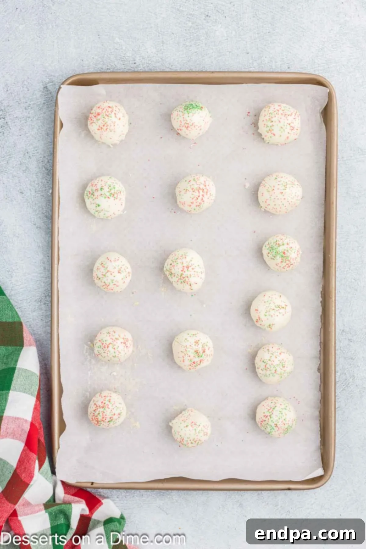 Cake balls on baking sheet topped with sprinkles.