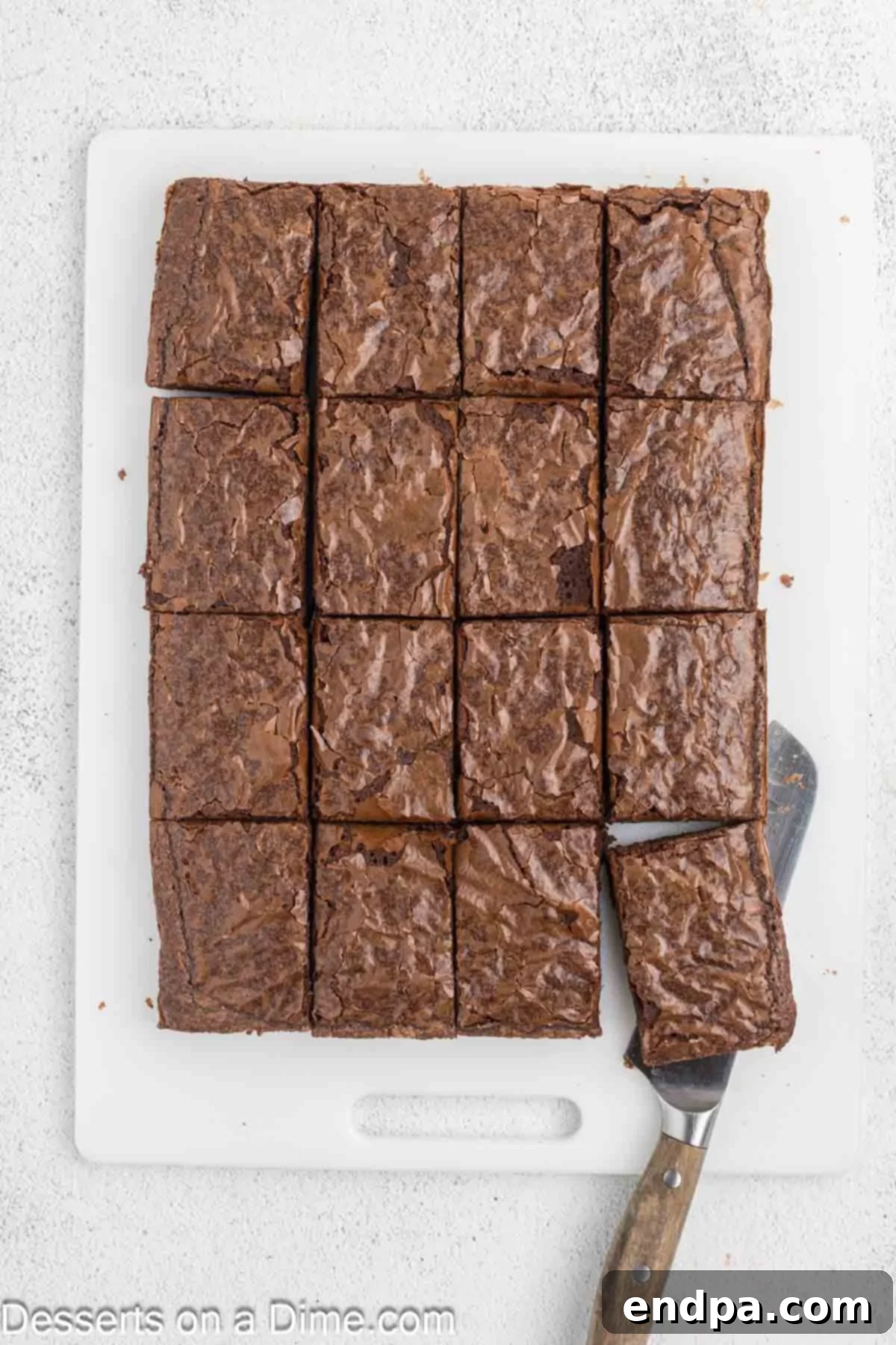 Christmas Antler Brownies 4 Freshly baked brownies, fully cooled, neatly cut into 16 uniform rectangle slices on a cutting board, ready for decoration.