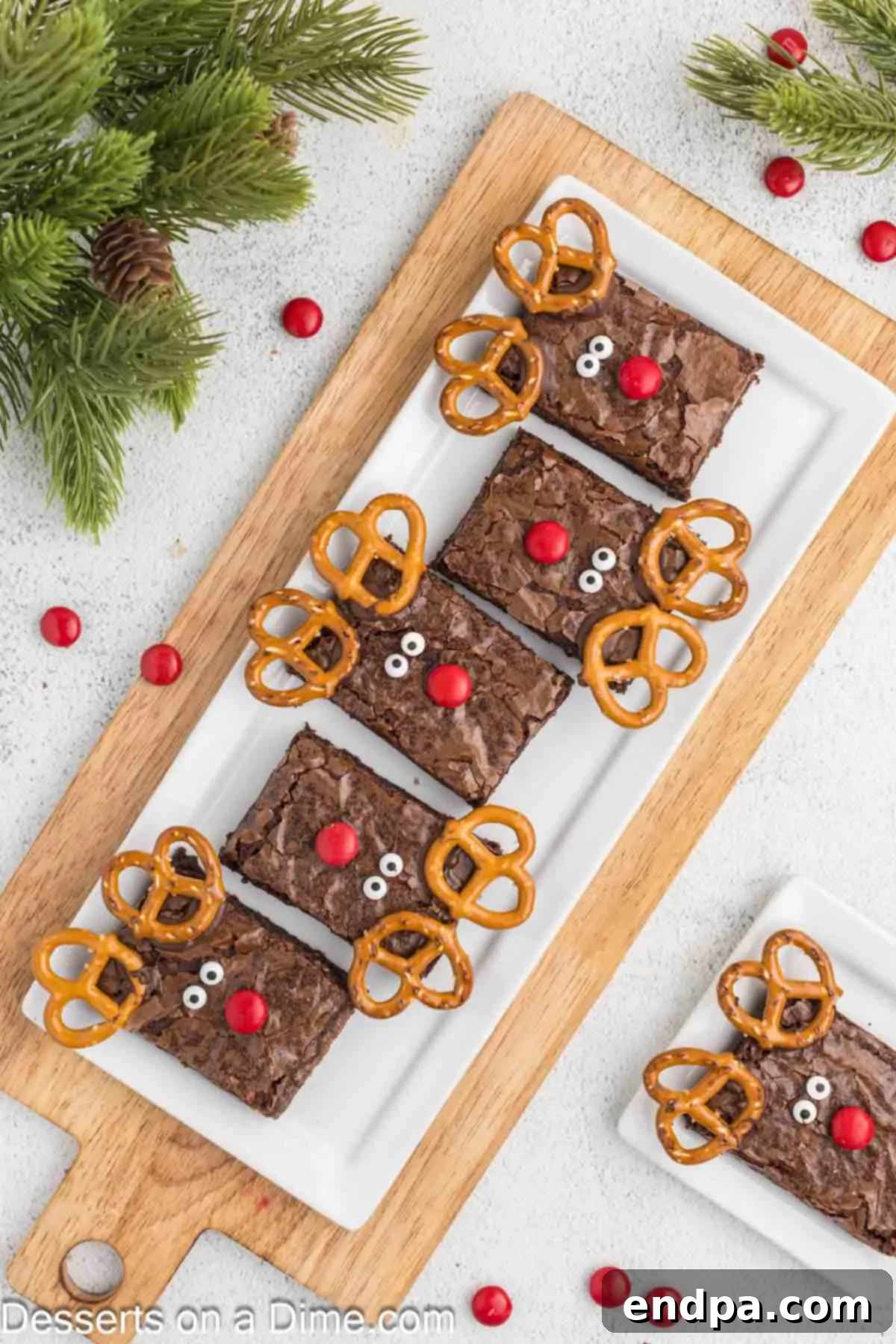 Christmas Antler Brownies 9 A festive wooden serving board laden with an assortment of charming Reindeer Brownies, ready to be presented at a holiday gathering.