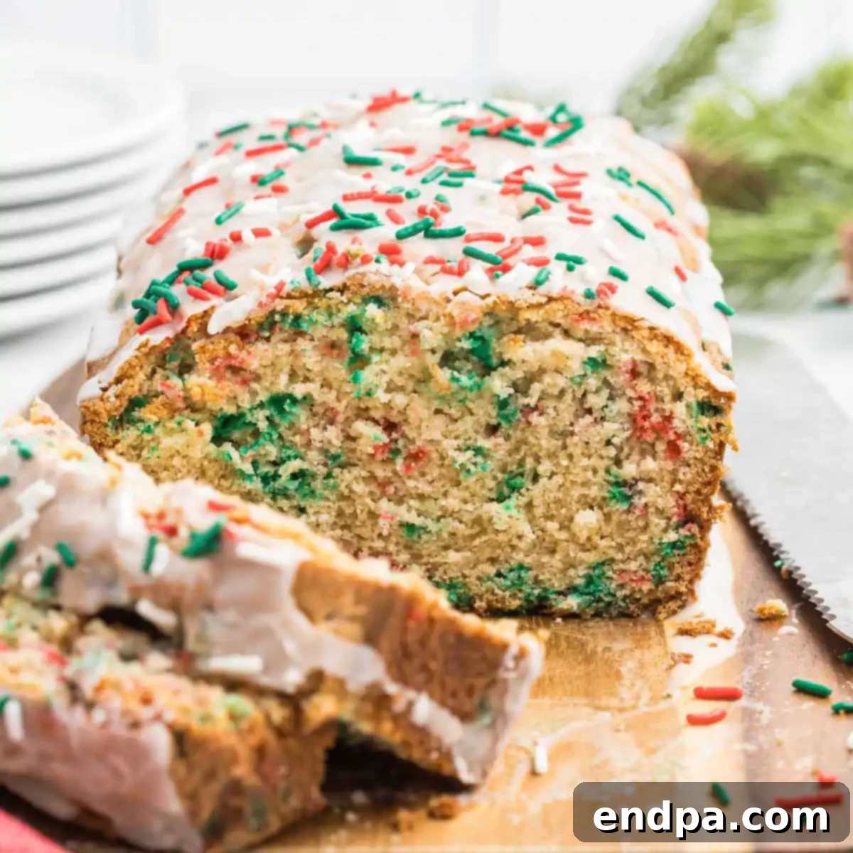 Yuletide Bake 11 Christmas bread being sliced, showing the tender crumb and festive sprinkles within.
