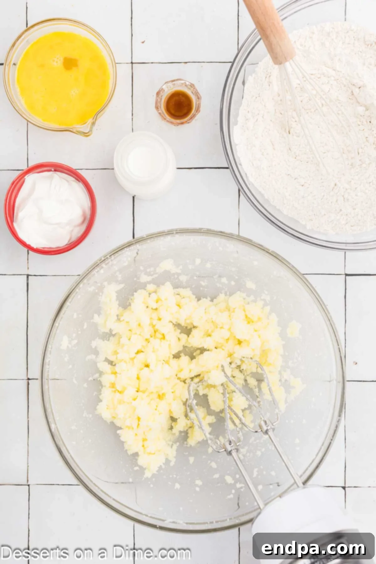 Yuletide Bake 4 Softened butter and granulated sugar being creamed together in a mixing bowl with an electric mixer until light and fluffy.